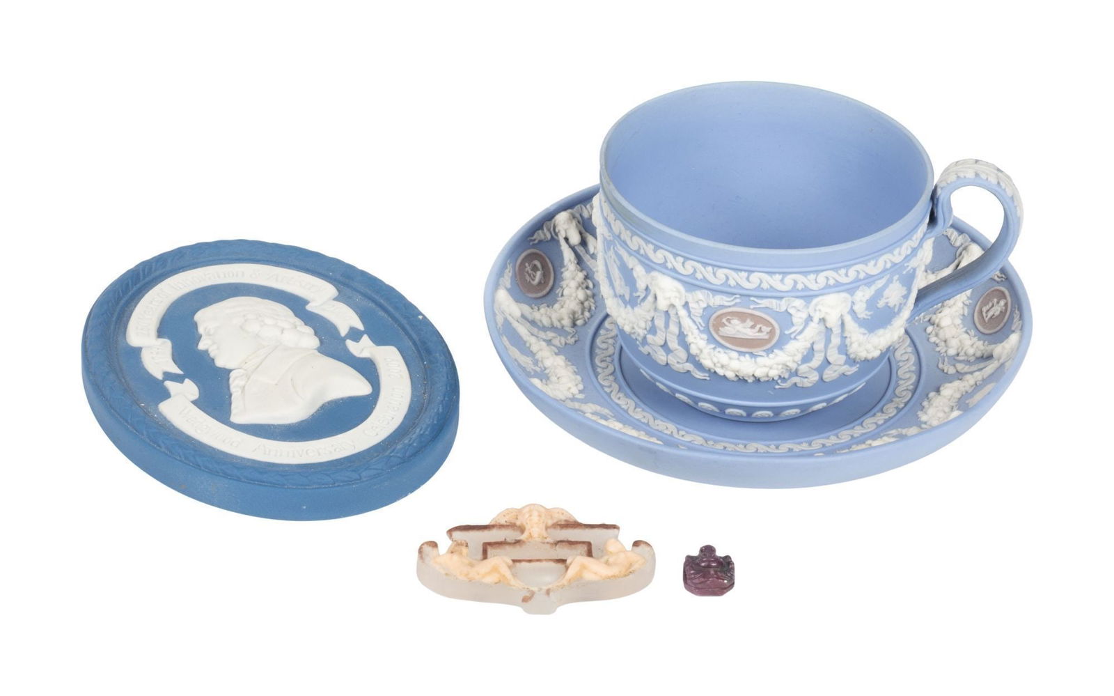 Whoopi Goldberg | Assorted Wedgwood Items: A group of items, including a tricolor Jasperware tea cup and saucer, an oval blue Jasperware 250 year Wedgwood anniversary 2009 museum exhibition medallion, a small pate-de-verre faun and nymph plaqu