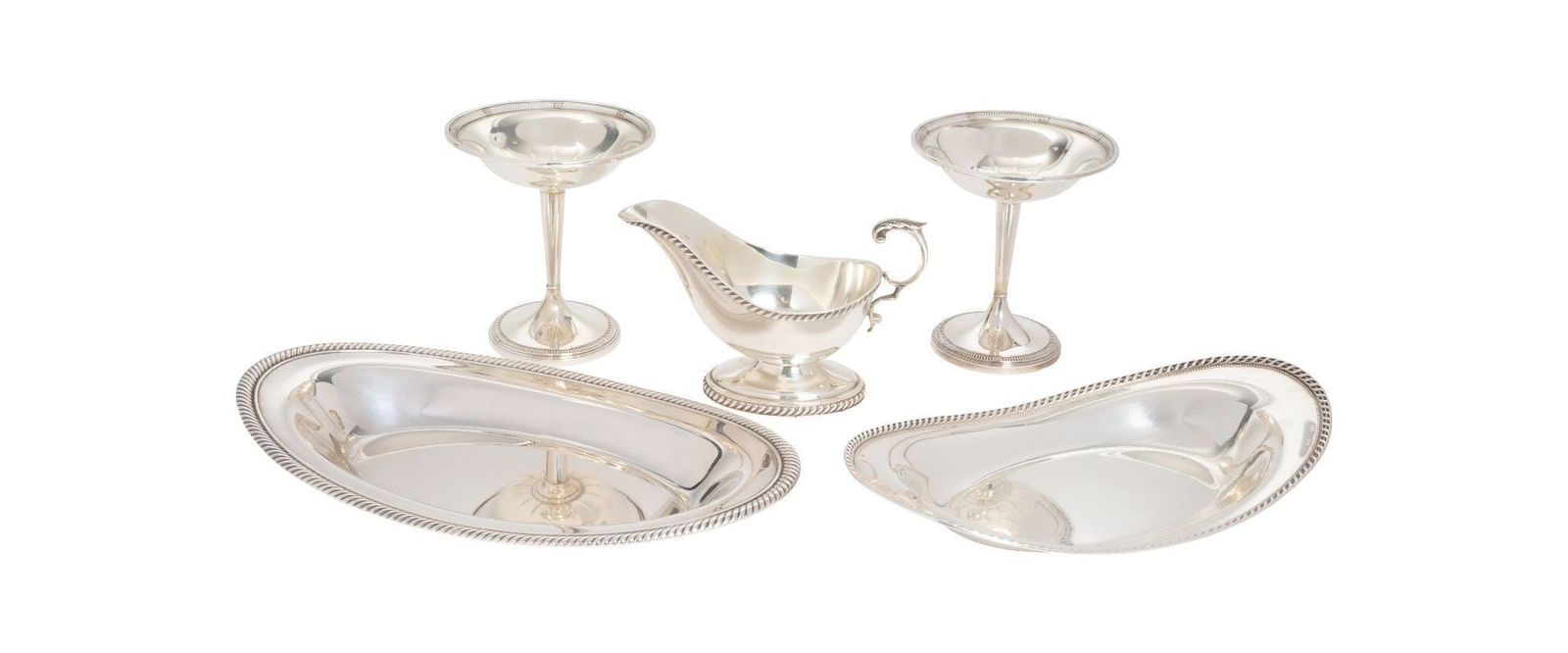 Whoopi Goldberg | Group of American Maker Sterling Tableware: Five sterling tableware articles, including a pair of compotes, two graduated trays, and a sauce boat. By various 20th century American makers. 35.80 troy oz. Largest 7.25 x 1.25 inches From the Colle
