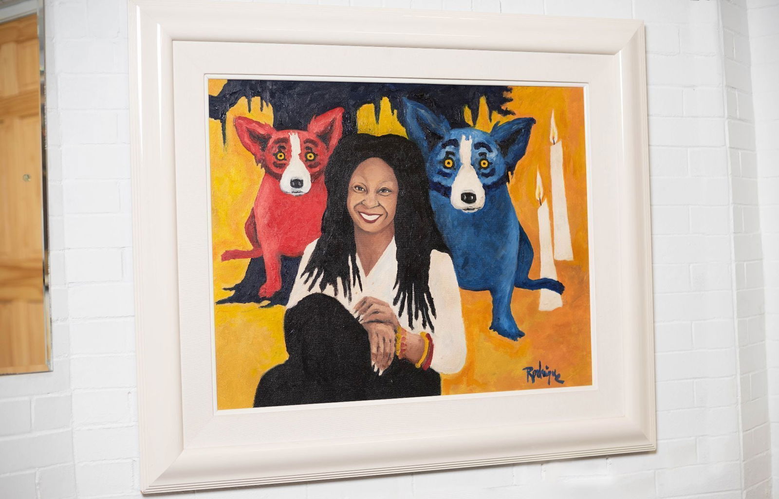 Whoopi Goldberg | George Rodrigue Whoopi Goldberg Blue Dog Portrait: A portrait of Whoopi Goldberg with a red and a blue dog oil on canvas, signed lower right by George Rodrigue (American 1944-2013). Sight: 24 x 30 inches; Framed: 35.5 x 40.5 inches From the Collection