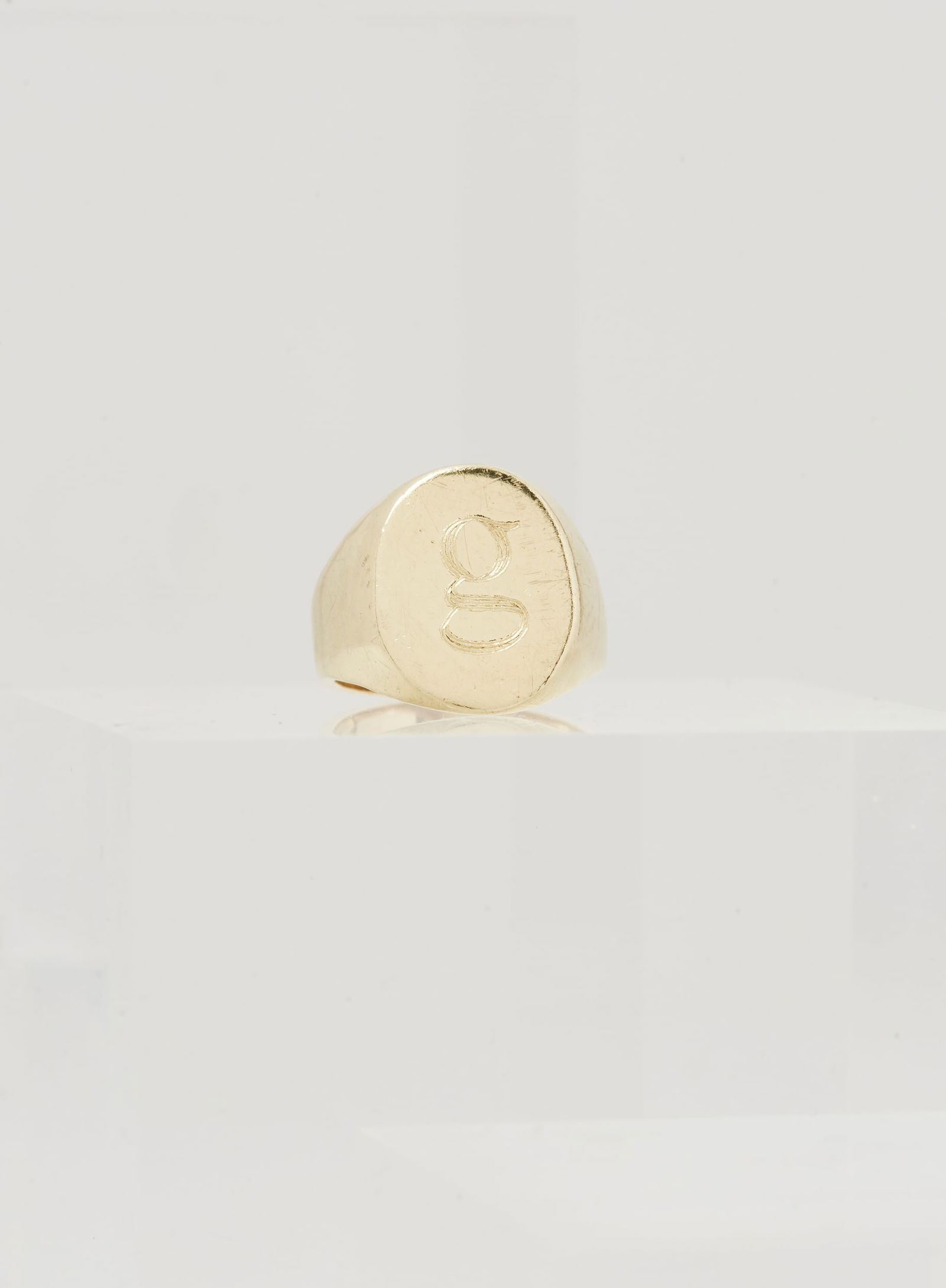 Gwyneth Paltrow | 18k Yellow Gold g Ring: An 18k yellow gold signet ring from the collection of Gwyneth Paltrow.Featuring a polished band engraved with a lowercase “g” at the top. The ring is a size 3 and is marked 18k.Gwyneth Pal