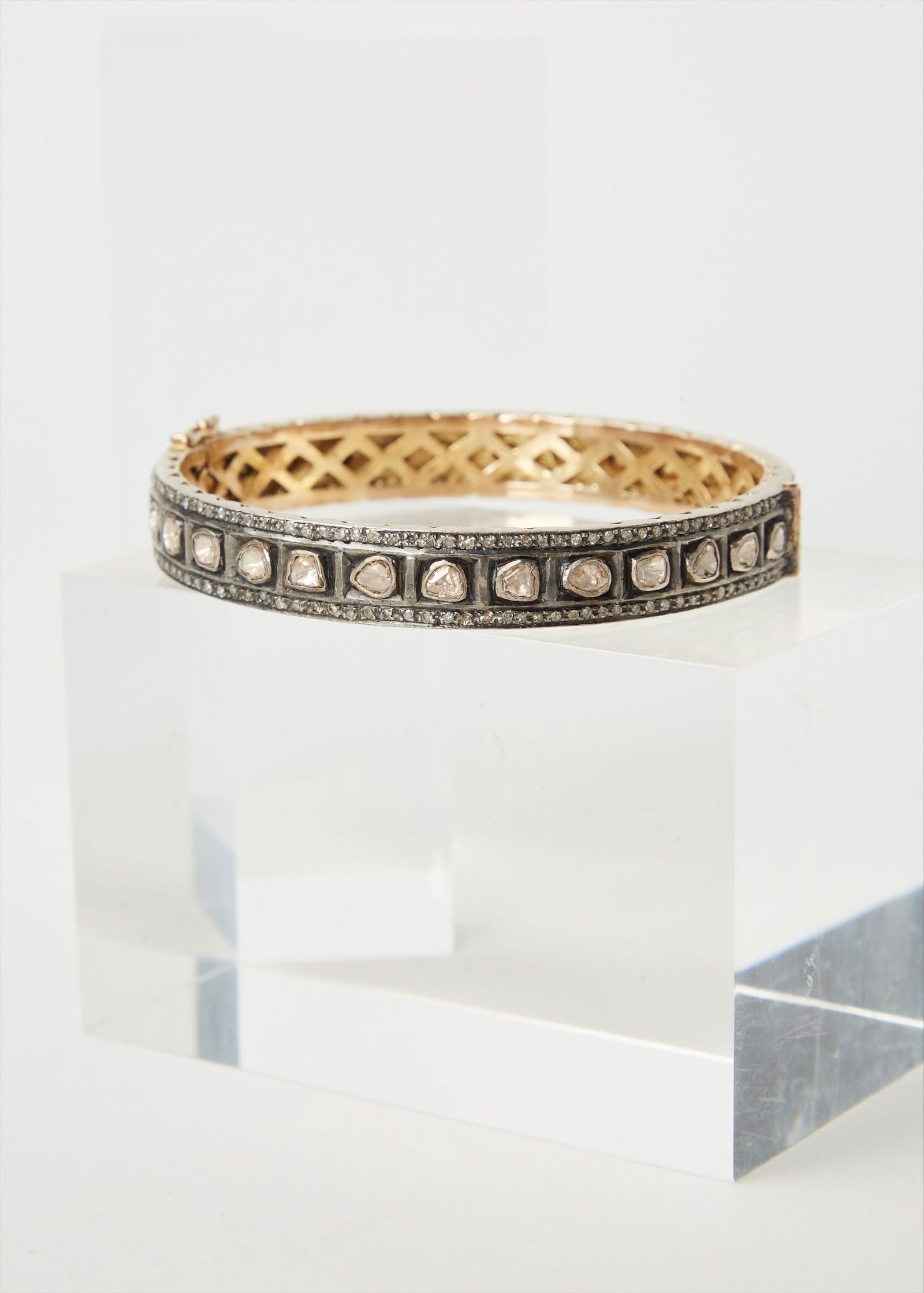 Gwyneth Paltrow | 18k Yellow Gold and Diamond Bangle Bracelet: A sterling silver 18k yellow gold and diamond bangle bracelet from the collection of Gwyneth Paltrow.Designed in the Indian style. The hinged rigid bangle is fully decorated with table-cut diamonds fr