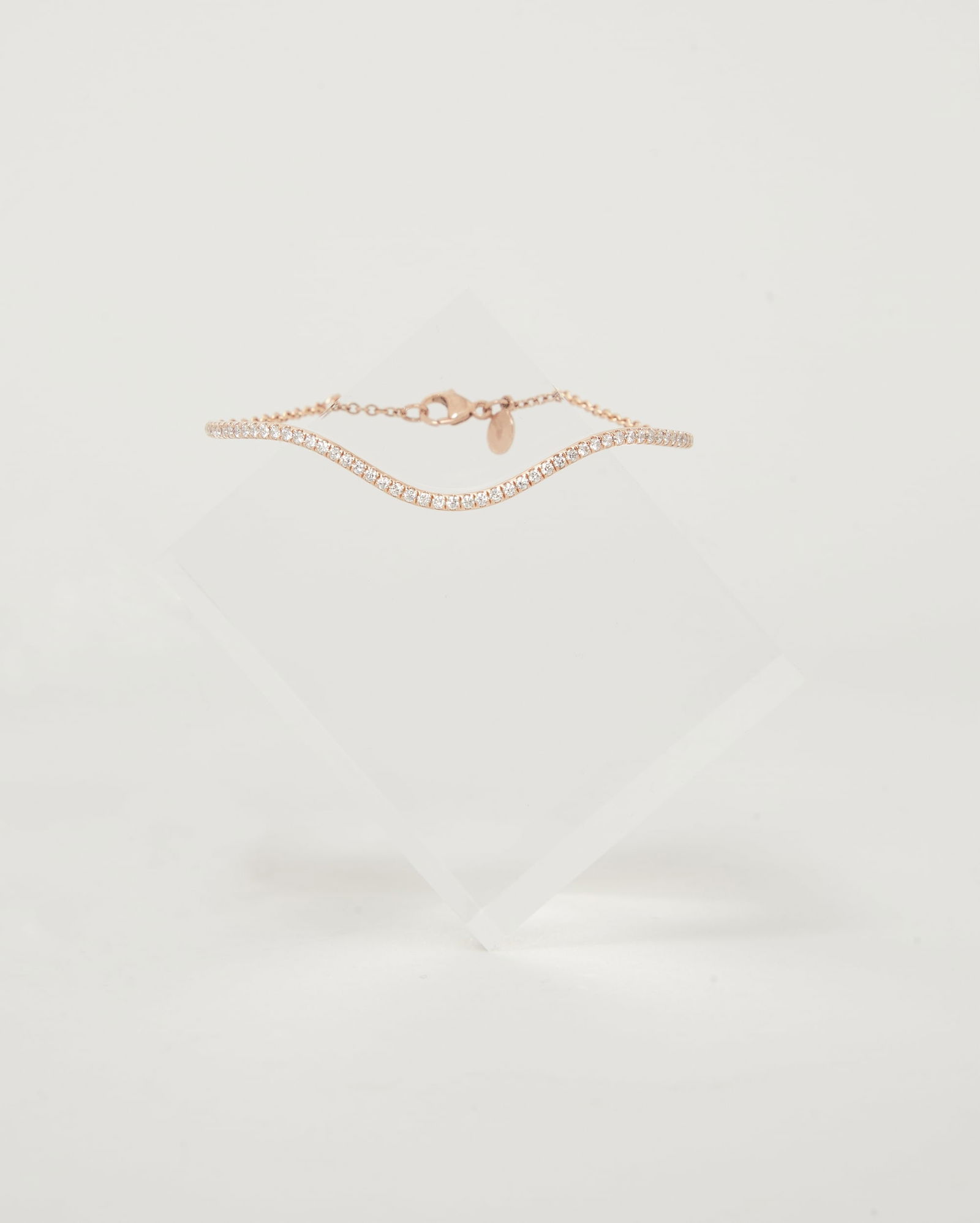 Gwyneth Paltrow | Bondeye 14k Rose Gold Diamond Bracelet: 14k rose gold and diamond bracelet designed by Bondeye from the collection of Gwyneth Paltrow.The top features a curving rigid line fully set with circular-cut diamonds connected to a link bracelet ba