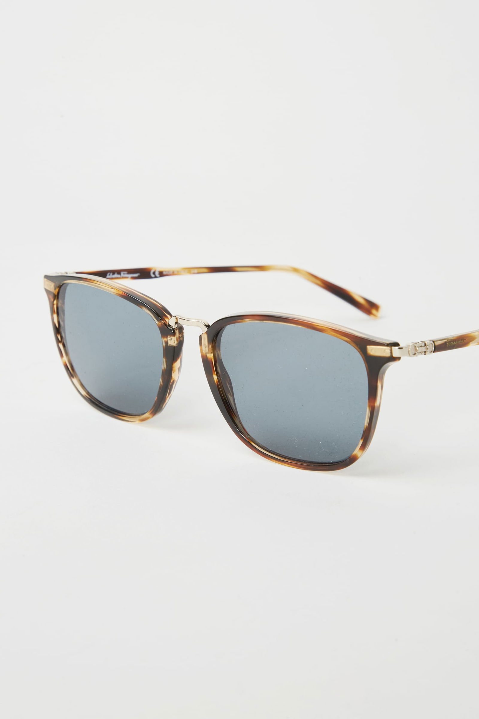 Gwyneth Paltrow | Salvatore Ferragamo Sunglasses: Salvatore Ferragamo brown square sunglasses from the collection of Gwyneth Paltrow. The sunglasses are a blue tint. 100% UV protection. Sunglasses case included. Lens width: 45mm Lens bridge