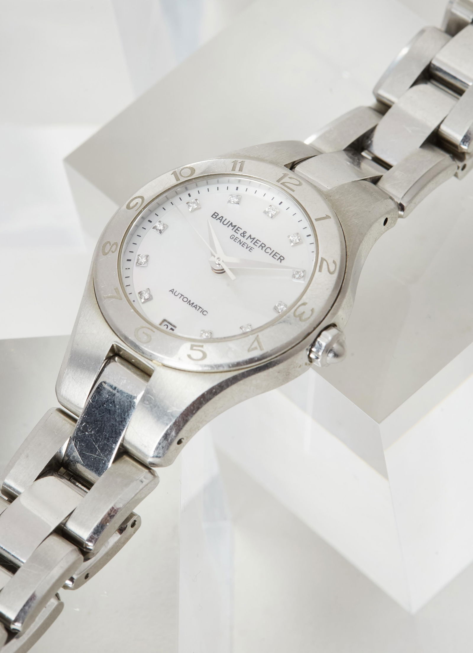 Gwyneth Paltrow | BAUME & MERCIER Stainless Steel Automatic Line Wristwatch: BAUME & MERCIER stainless steel automatic “Linea” wristwatch from the collection of Gwyneth Paltrow.Featuring a 21-jewel automatic movement, circular mother-of-pearl dial with diamond chap