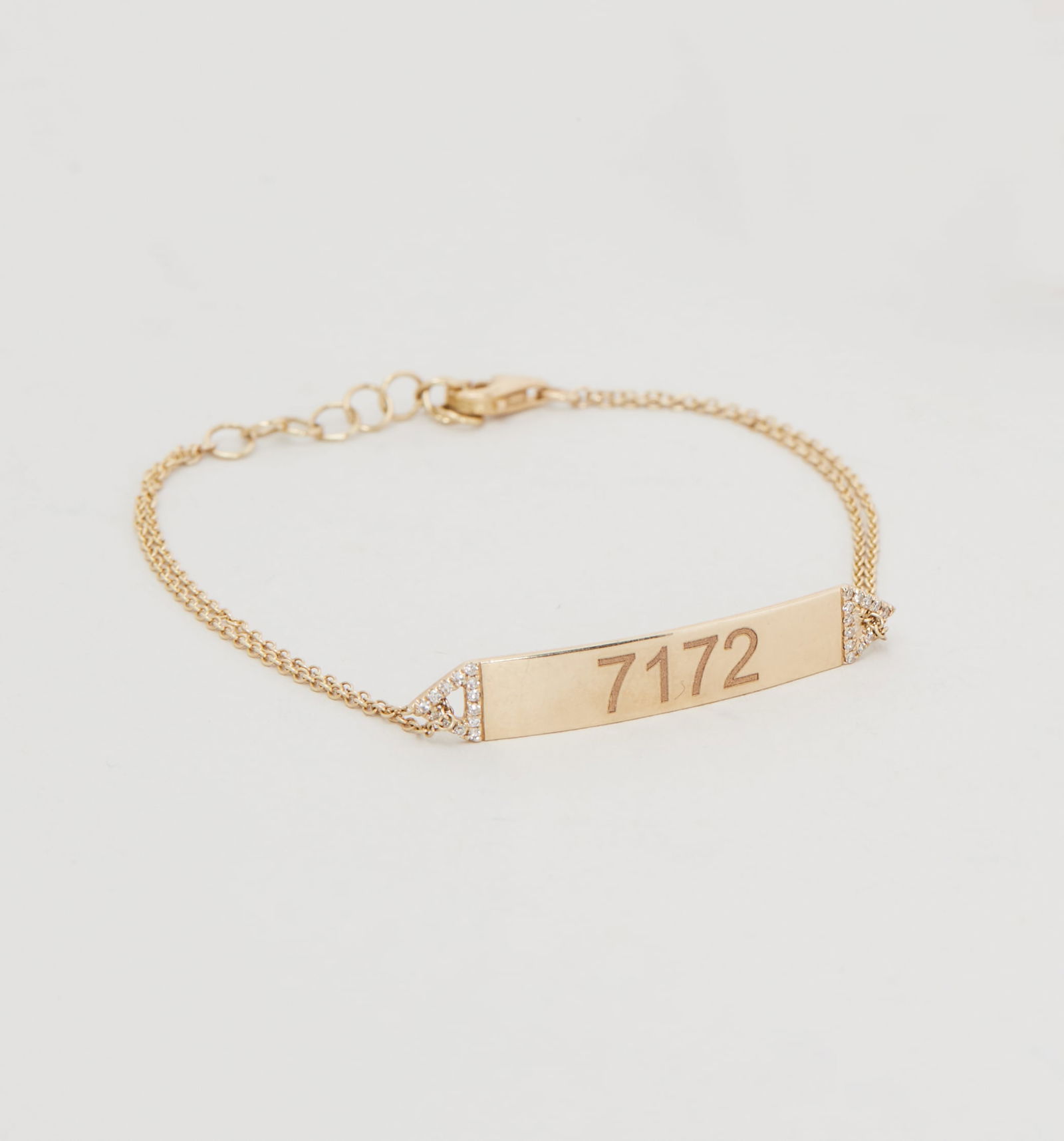 Gwyneth Paltrow | 14k Yellow Gold and Diamond Bracelet: A 14k Yellow Gold and Diamond Bracelet from the collection of Gwyneth Paltrow.A polished 14k yellow gold central plaque engraved “7172” accented with single-cut diamonds and join