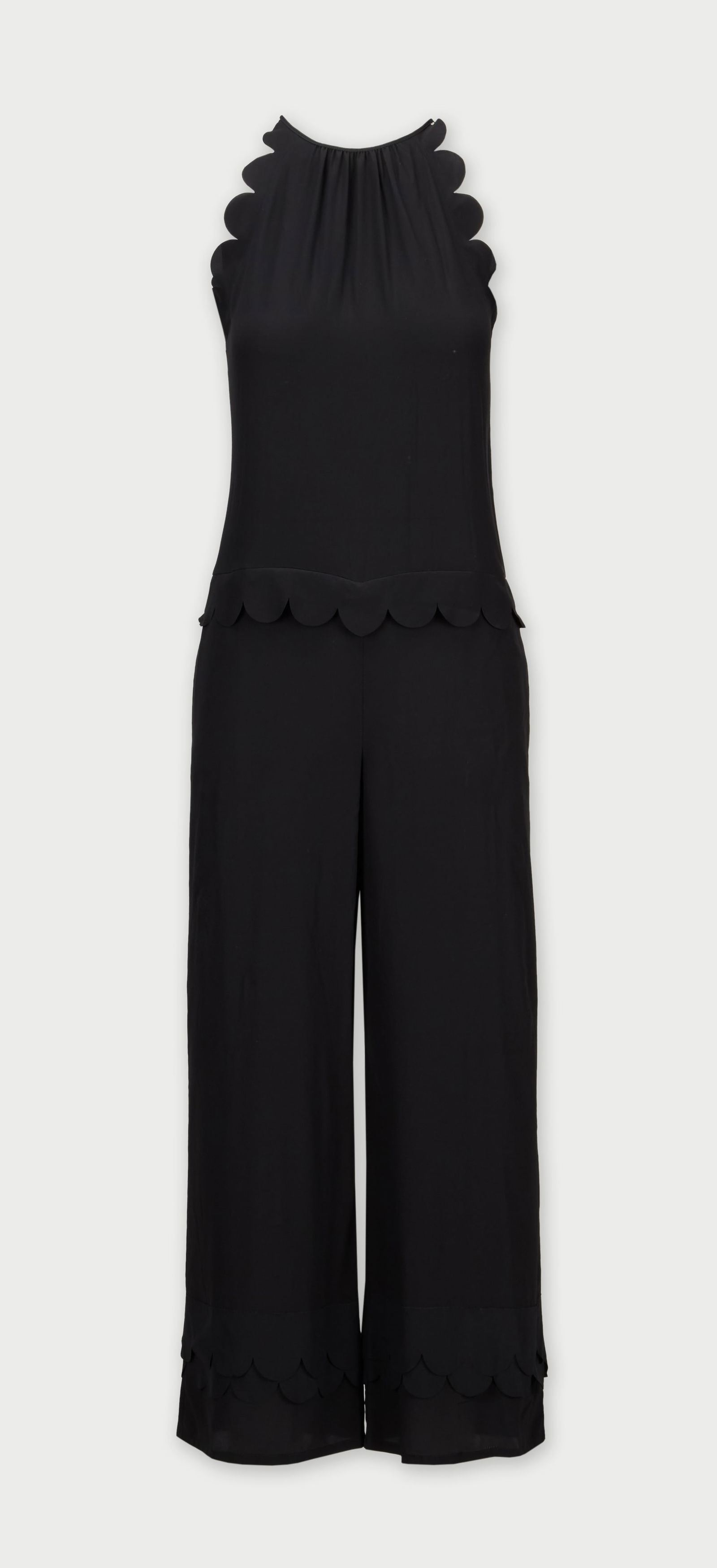 Gwyneth Paltrow | RED Valentino Black Jumpsuit: A black silk jumpsuit by RED Valentino, from the collection of Gwyneth Paltrow.Featuring a halter-style bodice accented with delicate scalloped edging along the armholes and upper shoulders. The fluid