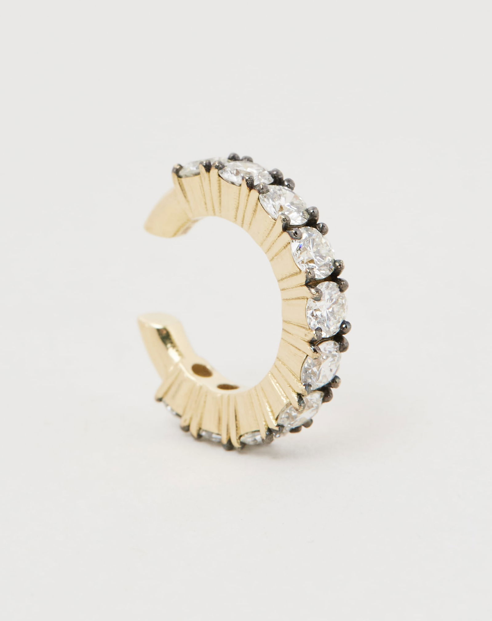 Gwyneth Paltrow | 18K Yellow Gold and Diamond Ear Cuff: An 18k yellow gold and diamond ear cuff from the collection of Gwyneth Paltrow. Designed as a linear arrangement of circular-cut diamonds with black-tipped prong detailing mounted in 18k