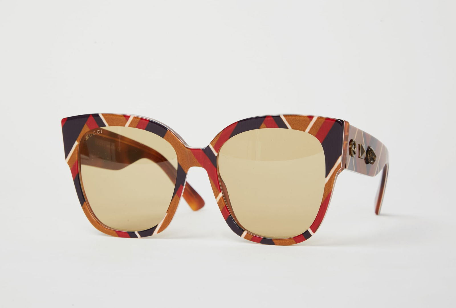 Gwyneth Paltrow | Gucci Cat-Eye Sunglasses: Gucci oversized chevron pattern oversized cat-eye sunglasses from the collection of Gwyneth Paltrow.Blue & neutral tortoiseshell acetate with interlocking G logo and studs on temple. Tinted lense