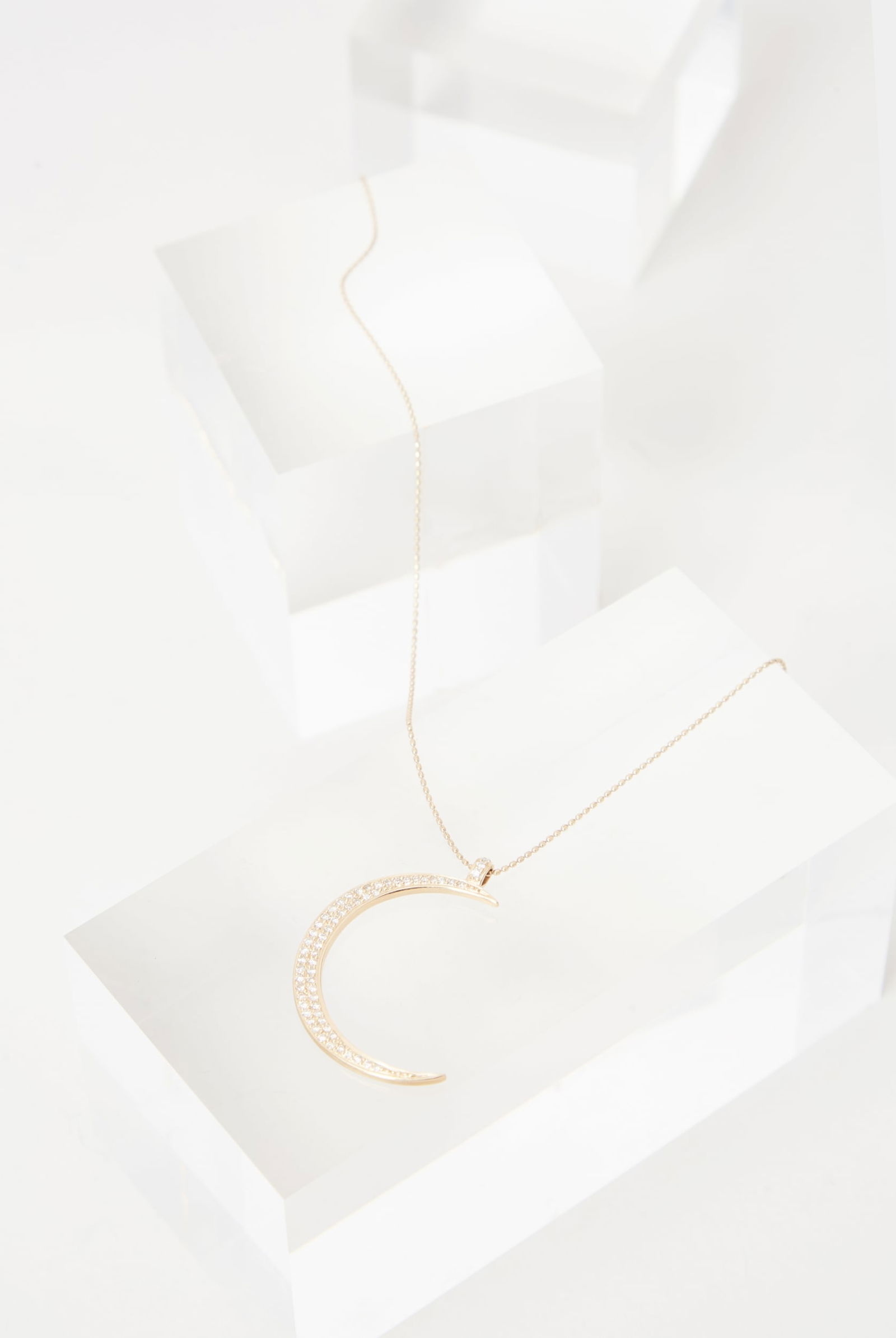 Gwyneth Paltrow | 2011 Photo Worn 14k Yellow Gold and Diamond Pendant Necklace (With Book): 14K Yellow Gold and Diamond Crescent Pendant Necklace from the collection of Gwyneth Paltrow. Paltrow was photographed wearing the necklace in the book My Father's Daughter: Delicious, Easy