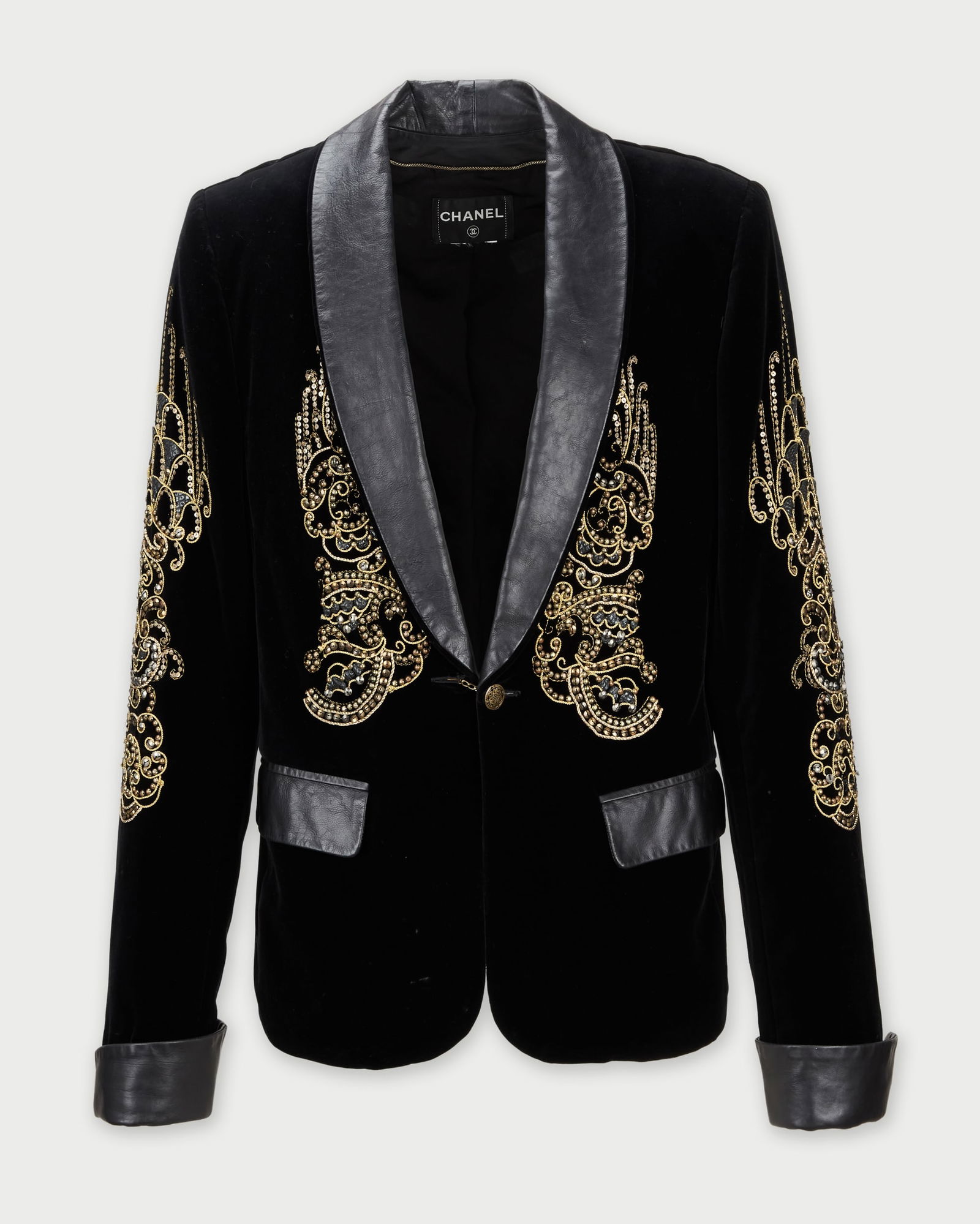 Chanel | 2010s Black Velvet Jacket: A Chanel black velvet jacket, designed by Karl Lagerfeld, from the collection Cameron Silver. The jacket features contrasting black leather trim on the shawl lapels, a single button, and flap