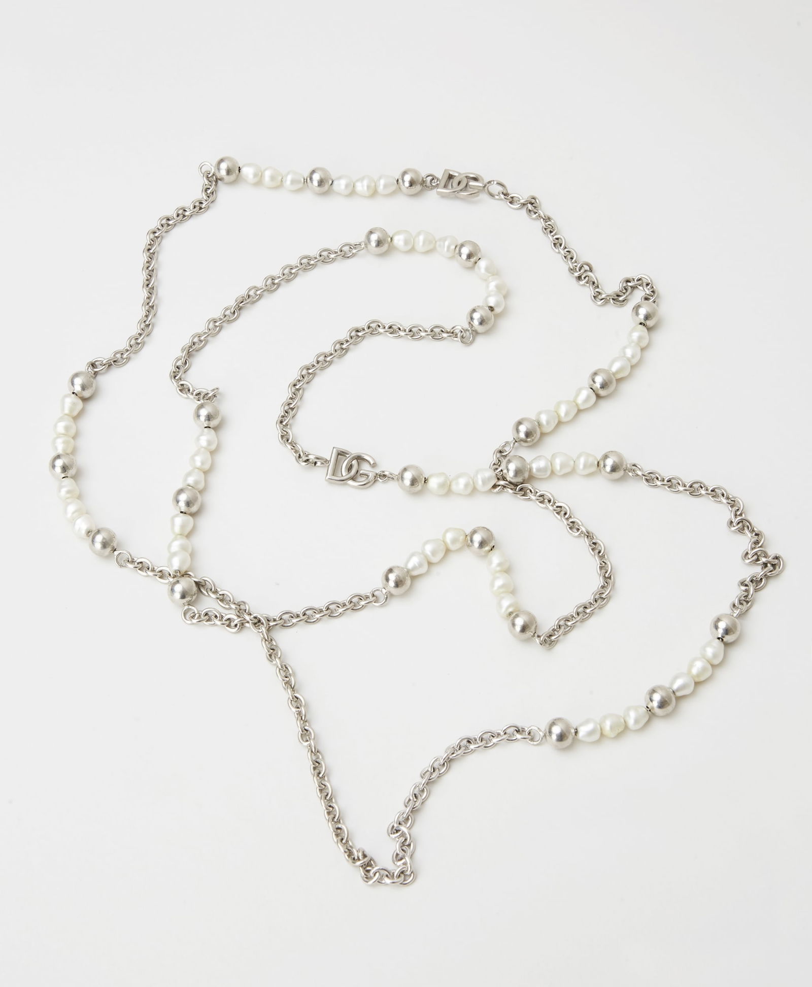 Dolce and Gabbana | Silver-Tone Metal Faux Pearl Necklace: Dolce & Gabbana, silver-tone metal and faux pearl long chain necklace from the collection of Cameron Silver.The silver tone metal link necklace, spaced by silver tone beads, DG logo links and