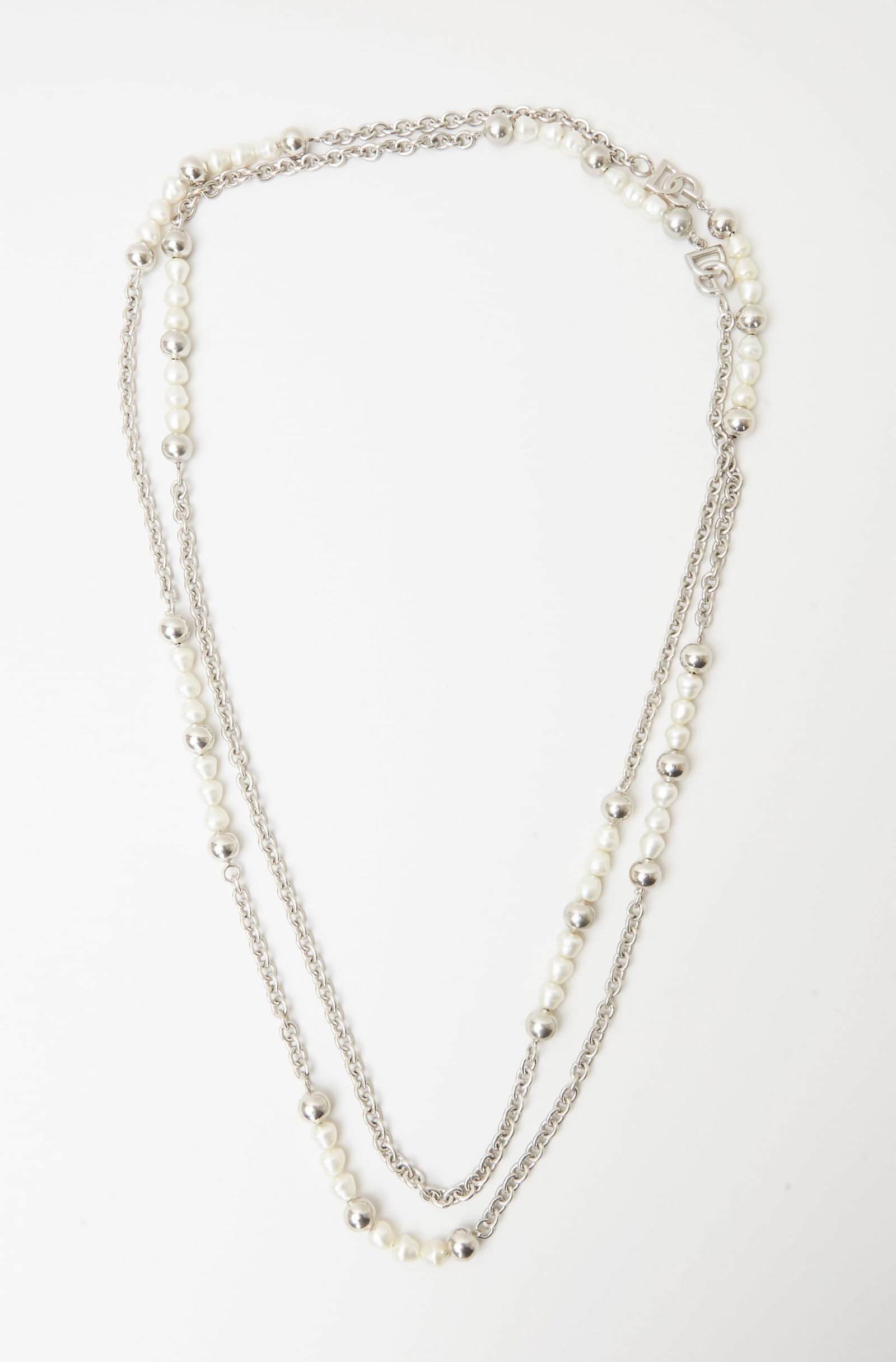 Dolce and Gabbana | Faux Pearl Necklace: Dolce & Gabbana, silver-tone and faux pearl long chain necklace from the collection of Cameron Silver.The silver-tone link necklace is accented with silver-tone beads, DG logo links, and simulated