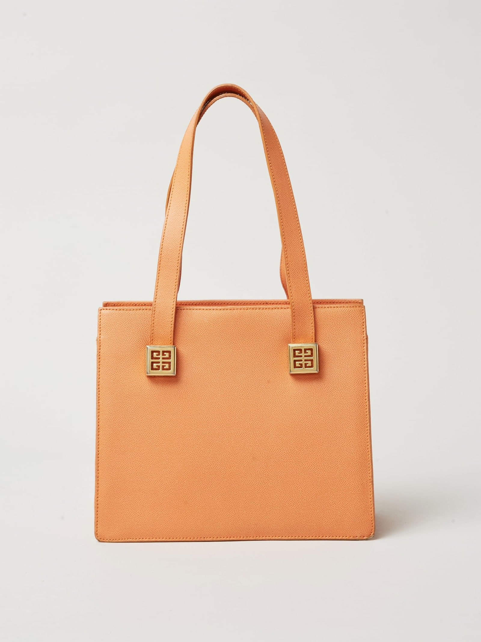 Givenchy | Lifetime Logo Orange Leather Purse: Givenchy lifetime logo orange leather purse. A structured pebbled-leather top-handle bag with a clean rectangular silhouette, double shoulder straps, and gold-tone square logo hardware at the