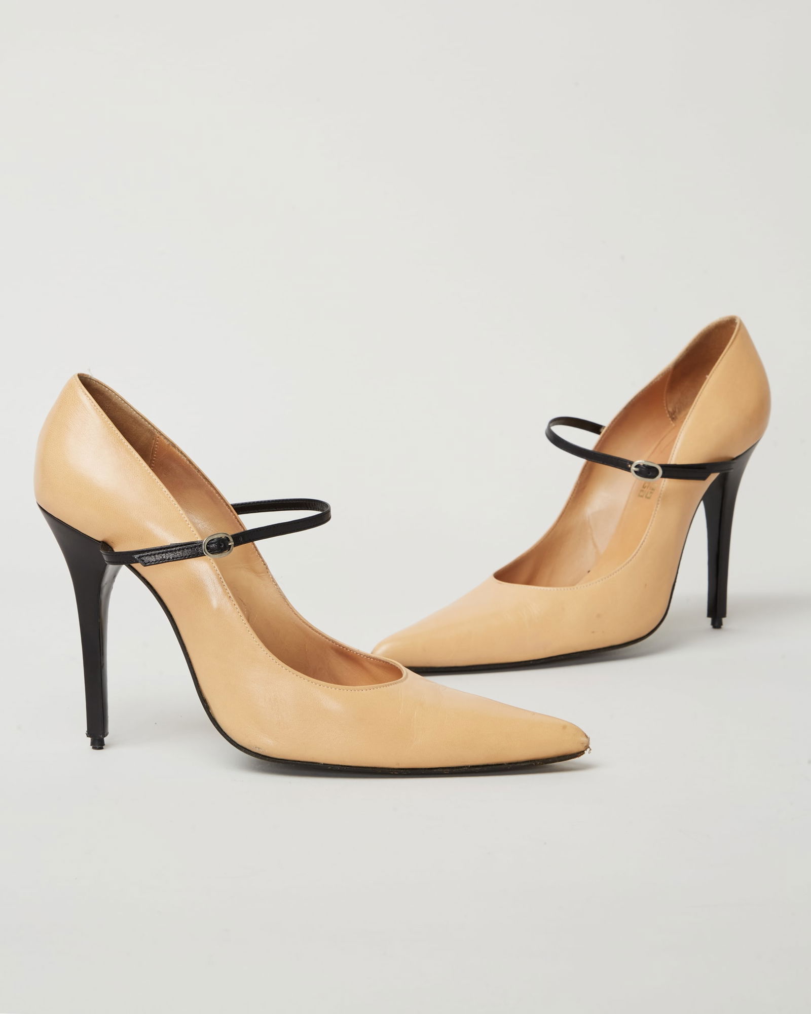 Givenchy | 1997-1998 Fall Collection By Alexander McQueen Leather Stiletto Pumps: A pair of two-tone Mary-Jane style stiletto leather pumps designed by Alexander McQueen for the Givenchy fall runway show titled “Lady Leopard.”The stilettos are composed of light beige le