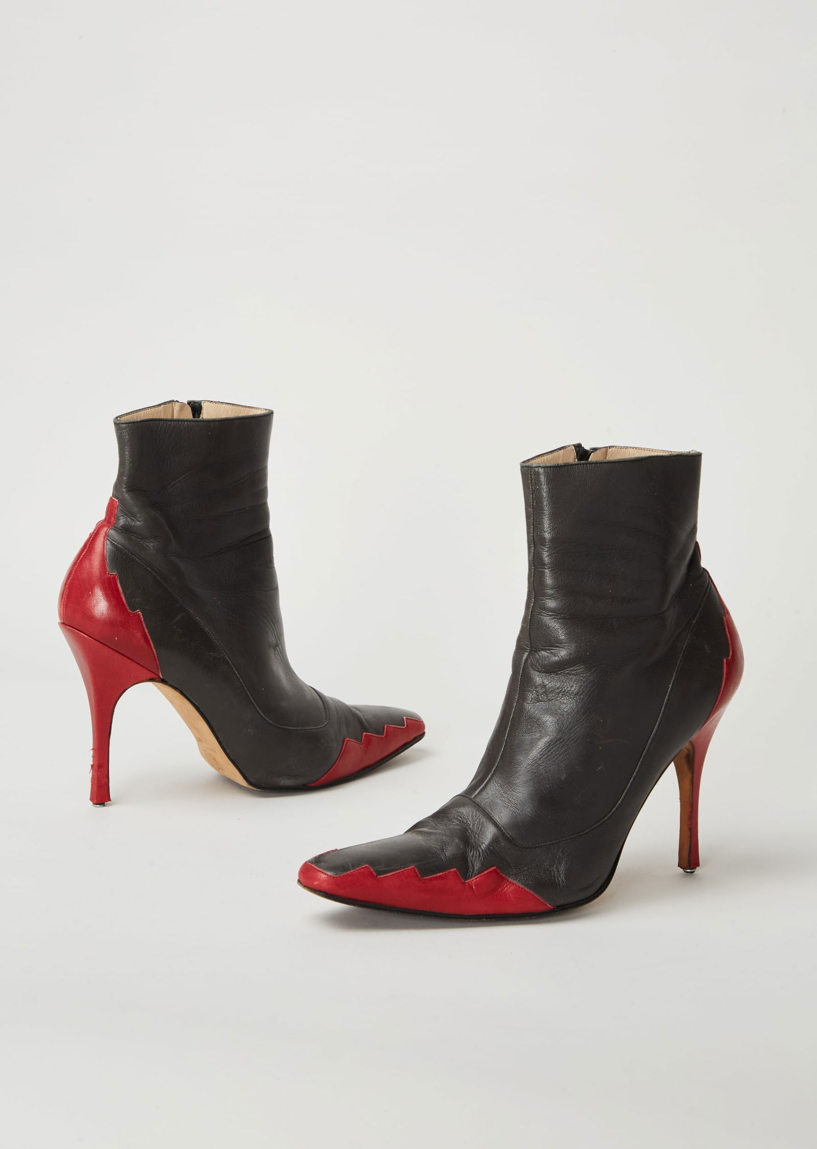 Givenchy | 1998-1999 Fall Collection By Alexander McQueen Leather “Blade Runner” Ankle: This is a pair of Givenchy two-tone leather ankle boots designed by Alexander McQueen for Givenchy's fall 1998-1999 runway collection titled, “Blade Runner.”The two-tone leather boots are