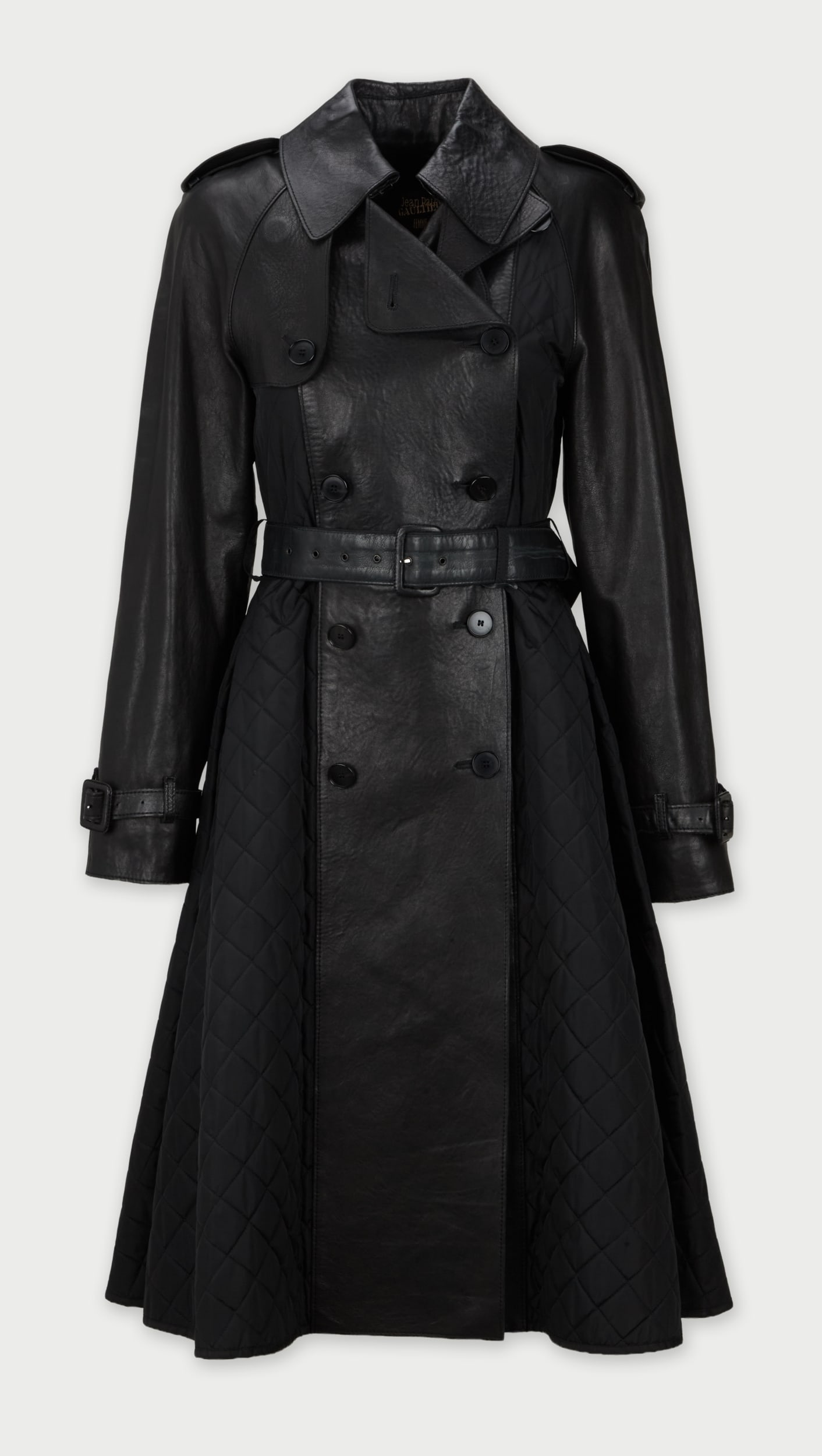 Jean Paul Gaultier | 90s Mid-Length Trench Coat: This is a Jean Paul Gaultier Femme mid-length trench coat, circa 1990s.The design features a mix of materials making the garment more eccentric but traditional in the elements of the cut. The trench