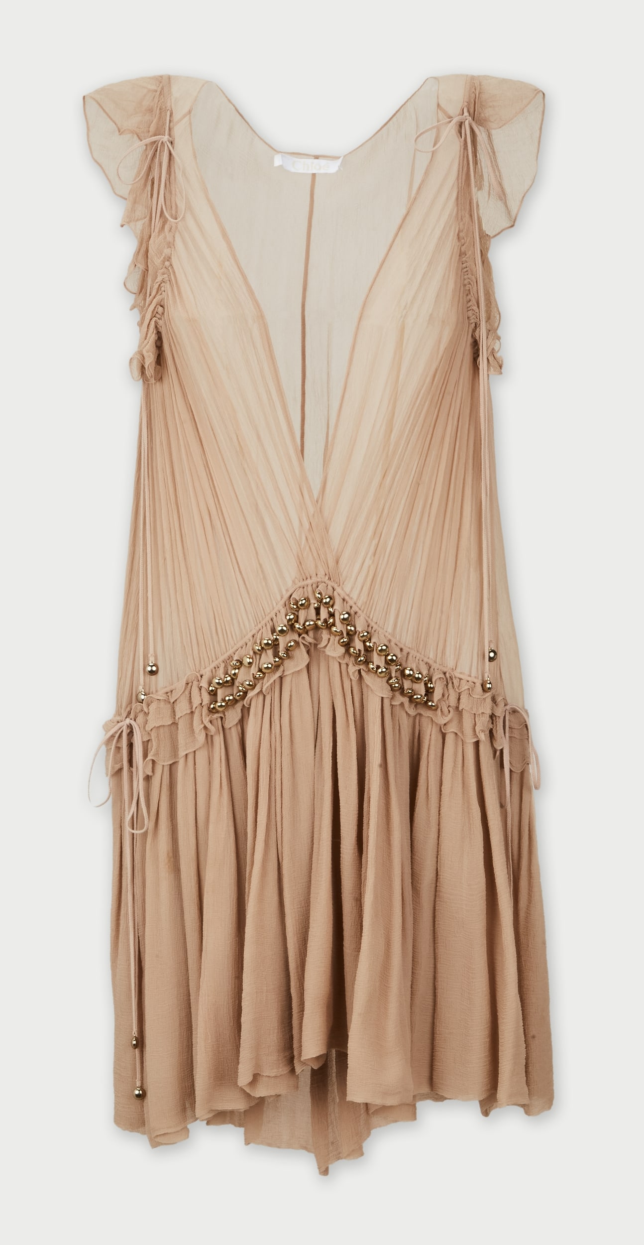 Chloé | 2016 Resort Collection Clare Waight Keller Semi-Sheer Silk Dress: Chloé dress, designed by Clare Waight Keller for the 2016 resort collection. Crafted from beige 100% silk georgette, this piece features a plunging V-neckline and cascading ruffled sleeves.