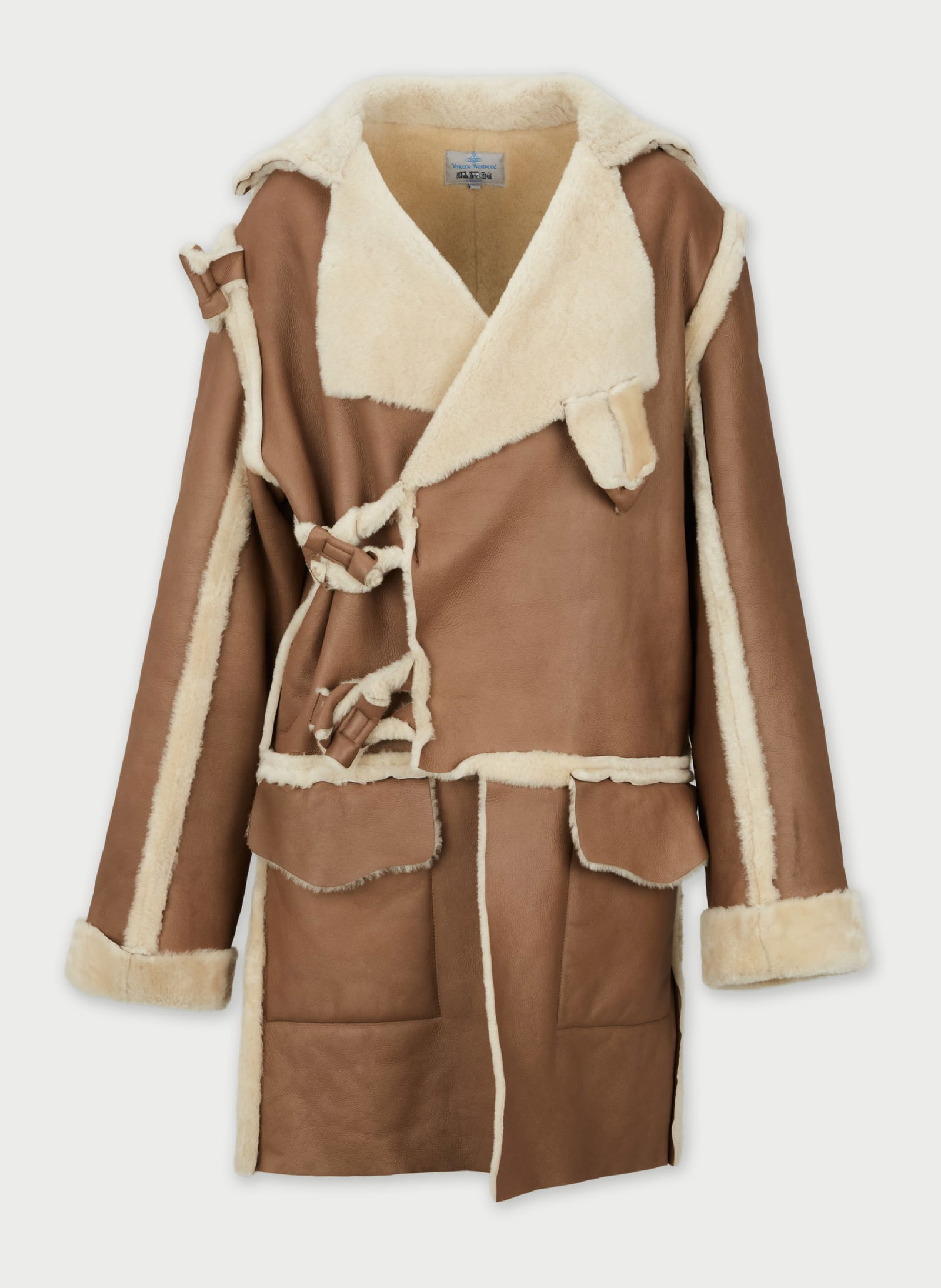 Vivienne Westwood Man | Shearling Coat: Vivienne Westwood Man Shearling Coat.Mid-length coat in leather, featuring an oversized notched collar with exposed shearling lining, open front with asymmetrical drape, long sleeves with turned-back