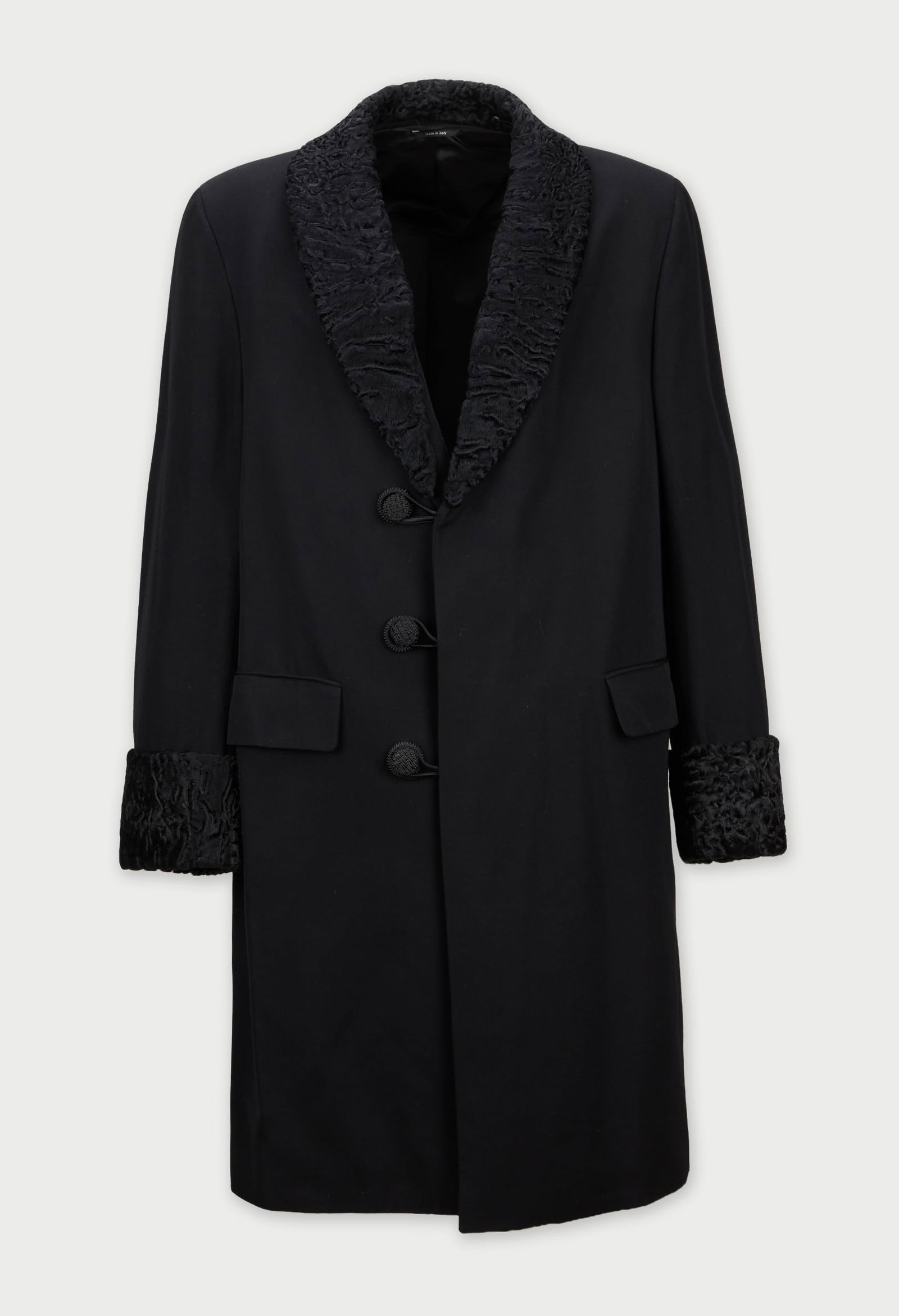 Saint Laurent | Black Wool Coat: A Saint Laurent double-breasted black coat, from the collection of Cameron Silver. A long-line black wool coat. It features a shawl collar and cuffs faced in textured, black fur. The coat
