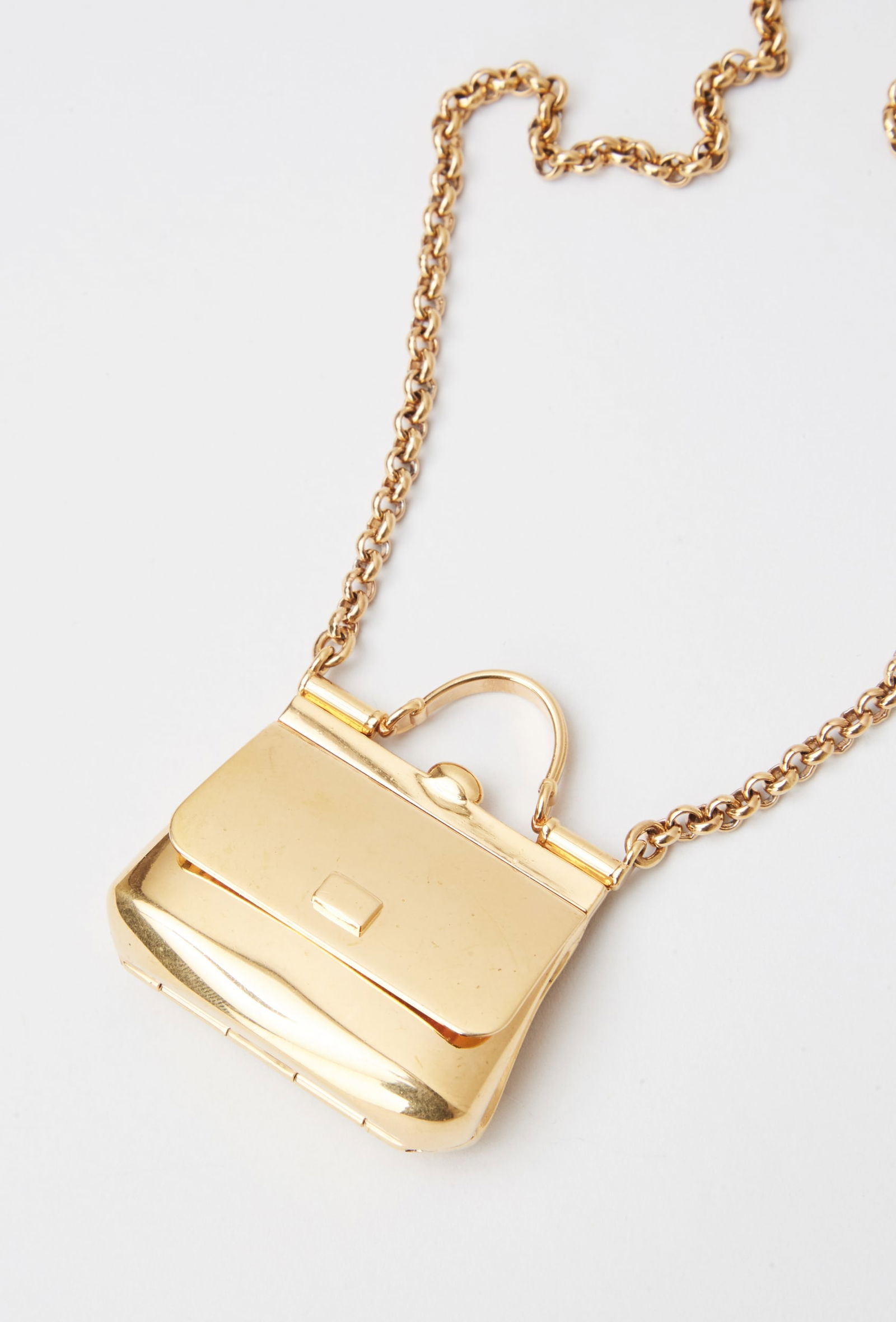 Dolce and Gabbana | Miss Sicily Pendant Necklace: Dolce & Gabbana “Miss Sicily” gold-tone pendant necklace from the collection of Cameron Silver. The pendant is designed as a gold-tone metal purse that opens to reveal a compartment