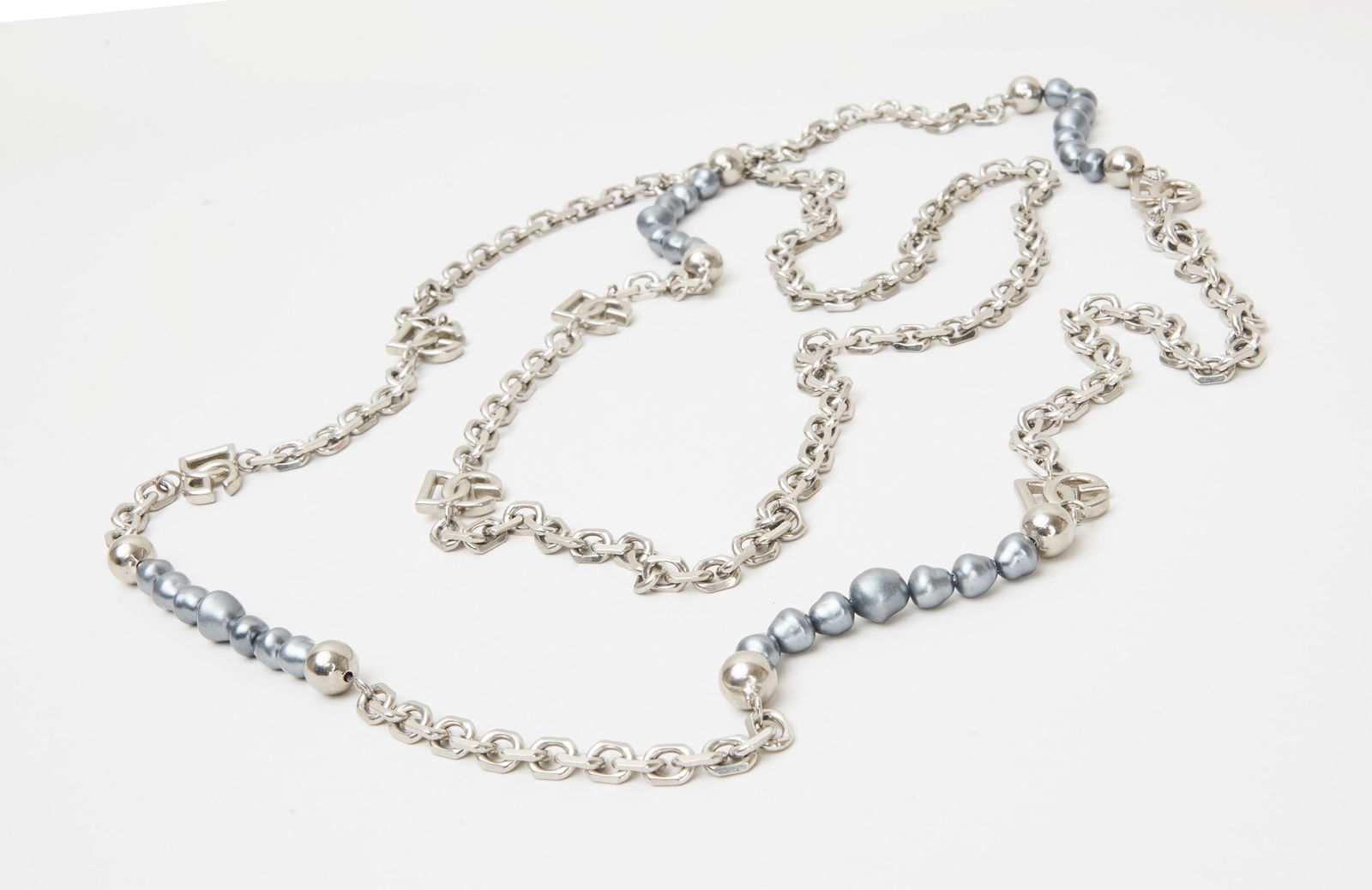 Dolce and Gabbana | Long Chain Necklace: Dolce & Gabbana, silver-tone metal and faux pearl long chain necklace from the collection of Cameron Silver.The silver-tone link necklace is accented with silver beads, DG logo links, and simulated