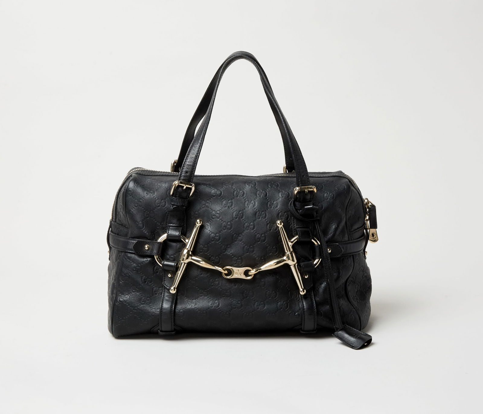 Gucci | 85th Anniversary Embossed Leather Handbag: This a Gucci black leather east-west style embossed monogram handbag design in celebration of the Italian design house 85th anniversary.The bag's outer material is leather with the “GG”