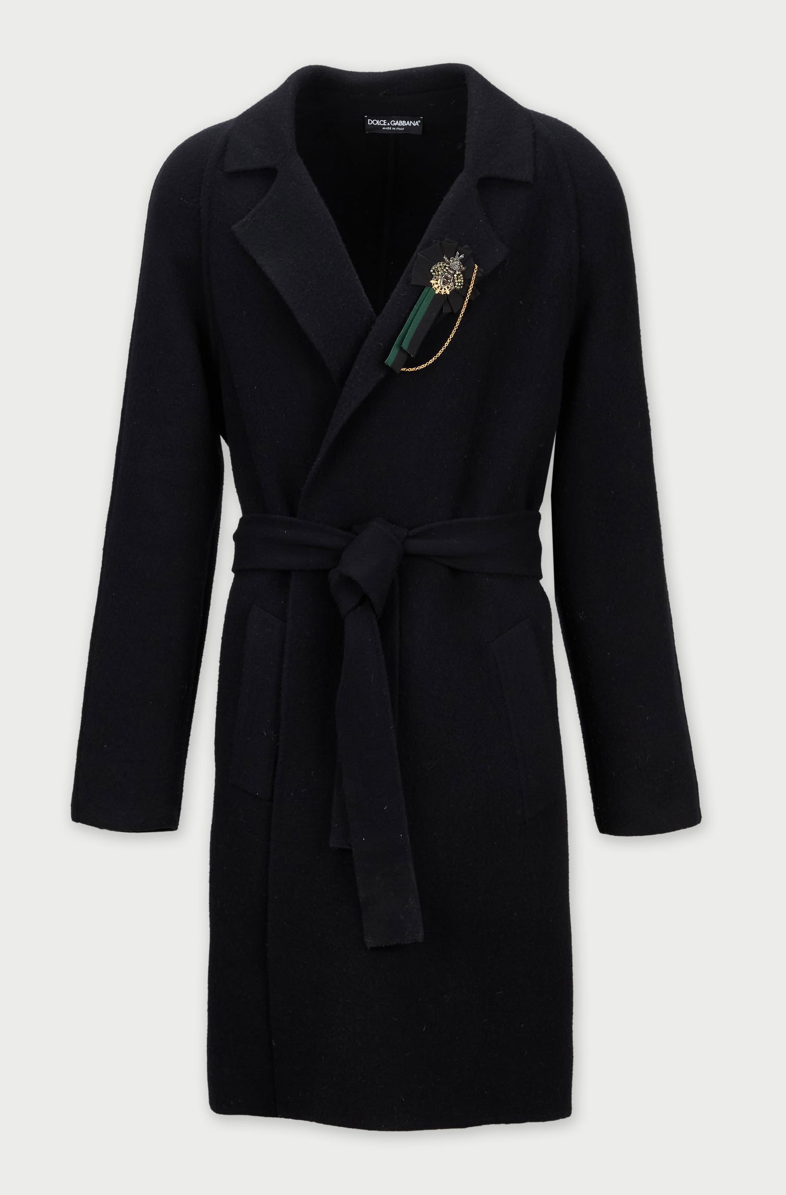 Dolce and Gabbana | Black Overcoat with Jewel Bee Motif Pin: A, knee-length Dolce & Gabbana overcoat, from the collection of Cameron Silver. The black wool overcoat features a relaxed, wrap silhouette secured by a belt cinched at the waist, and a wide