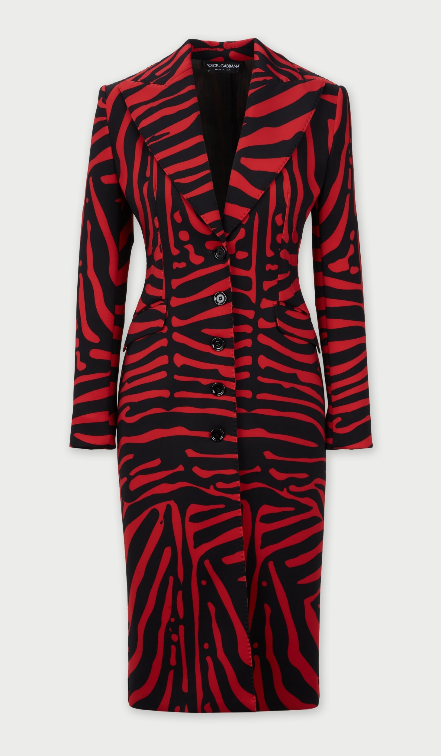 Dolce and Gabbana | Zebra Print Coat: A Dolce and Gabbana knee-length polyester blend, single-breasted, coat, featuring a red and black zebra print pattern through. Designed with wide notched lapels, single breasted front with multi