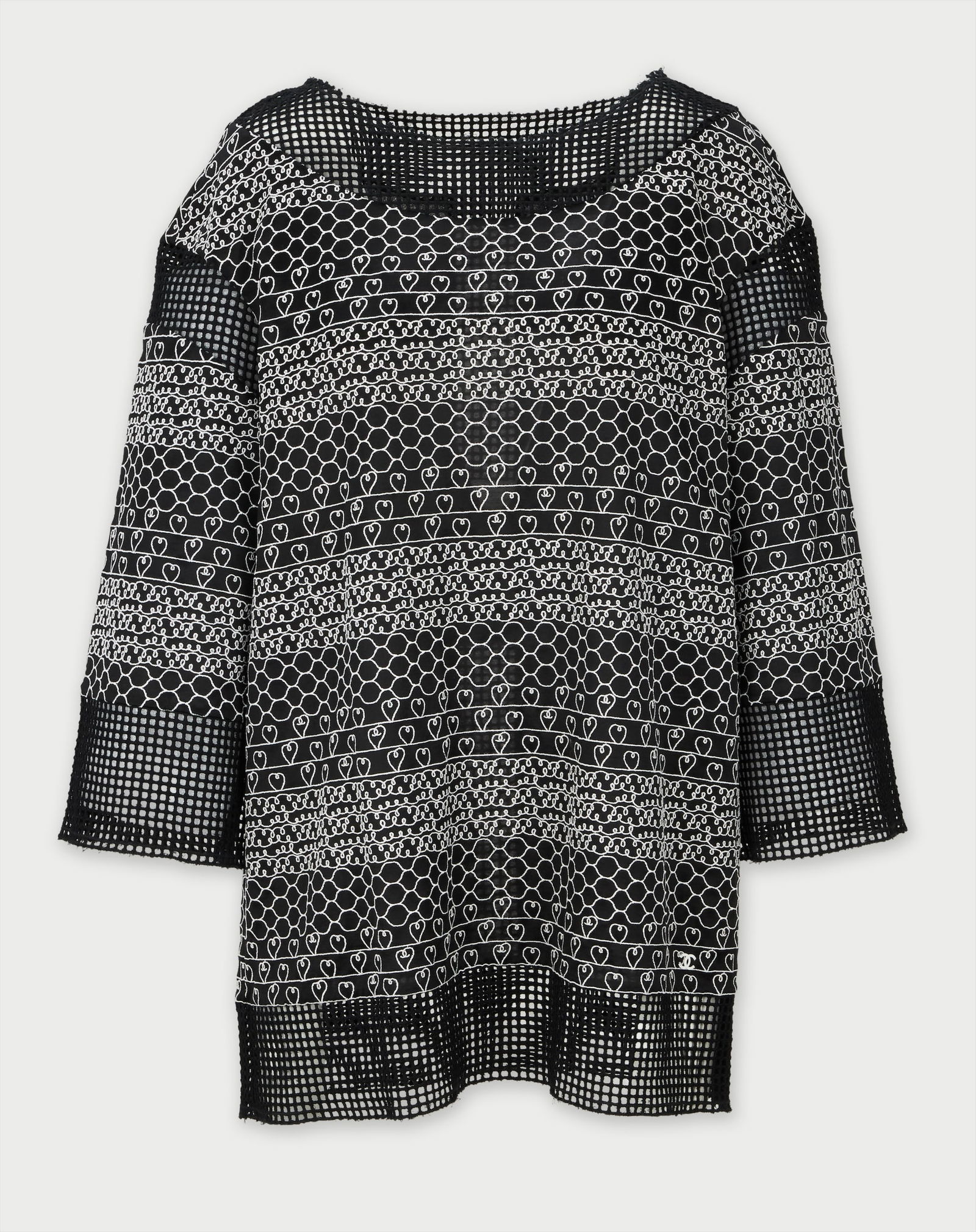 Chanel | Heart Tunic: Chanel cotton blend knit tunic with white heart logo motif throughout, circa 2013.Features a scoop neckline, long-sleeves, and open-knit trim at the neckline, cuffs, and hem. Pull-on style. Size 40.