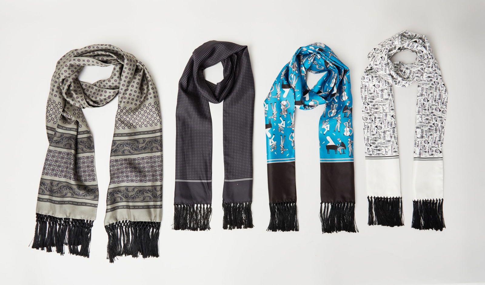 Dolce and Gabbana | Silk Scarves: A set of four silk scarves designed by Dolce & Gabbana, from the collection of Cameron Silver.Each piece is crafted in luxurious silk and presents a distinct motif: a vibrant electric blue scarf with