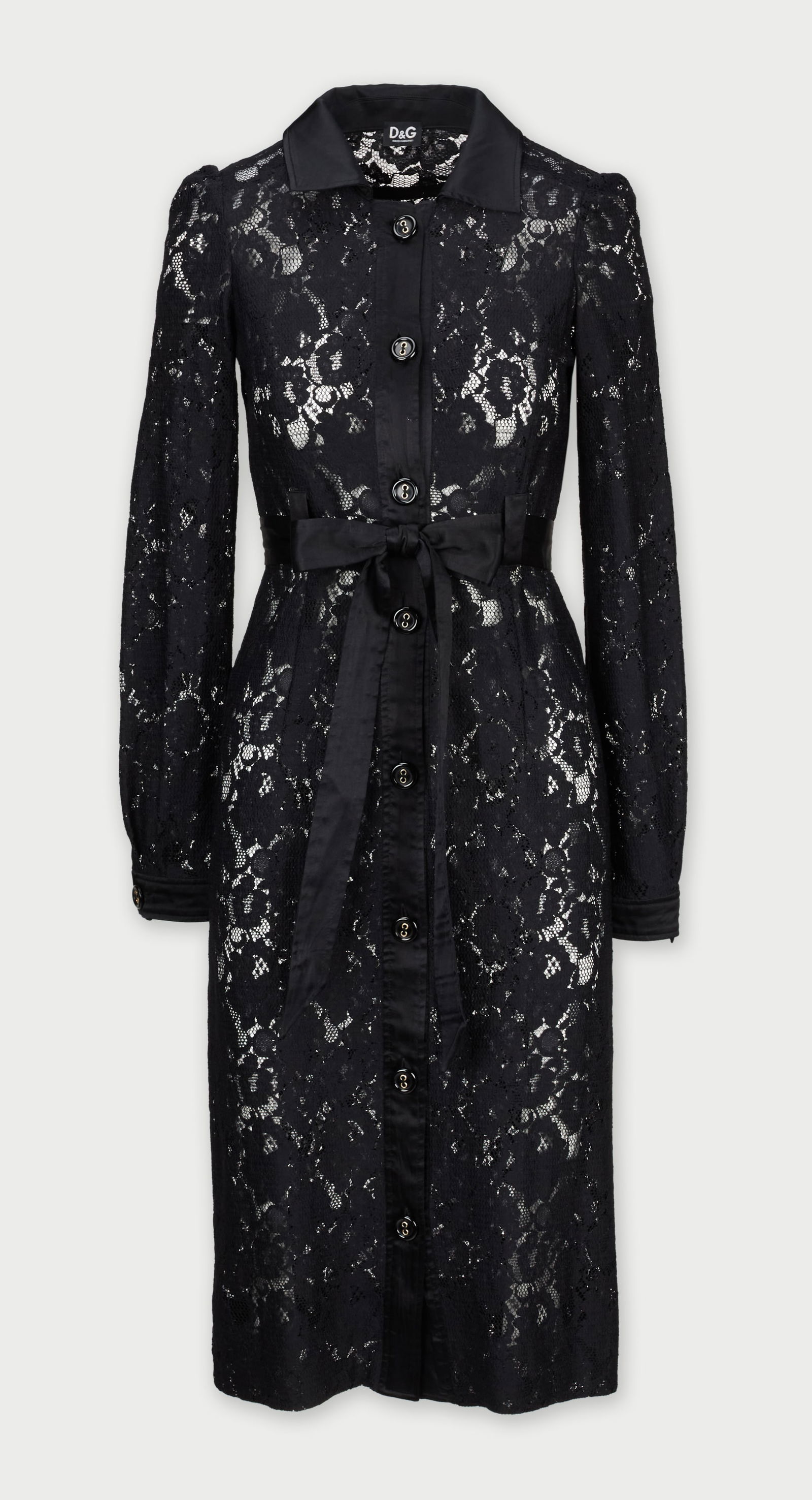 Dolce and Gabbana | Black Lace Shirt Dress: A Dolce and Gabbana black poly-blend lace midi dress, featuring a silk-blend pointed collar, long sleeves with buttoned cuffs, a silk-blend tie belt at the waist, and a silk-blend button-up front clos