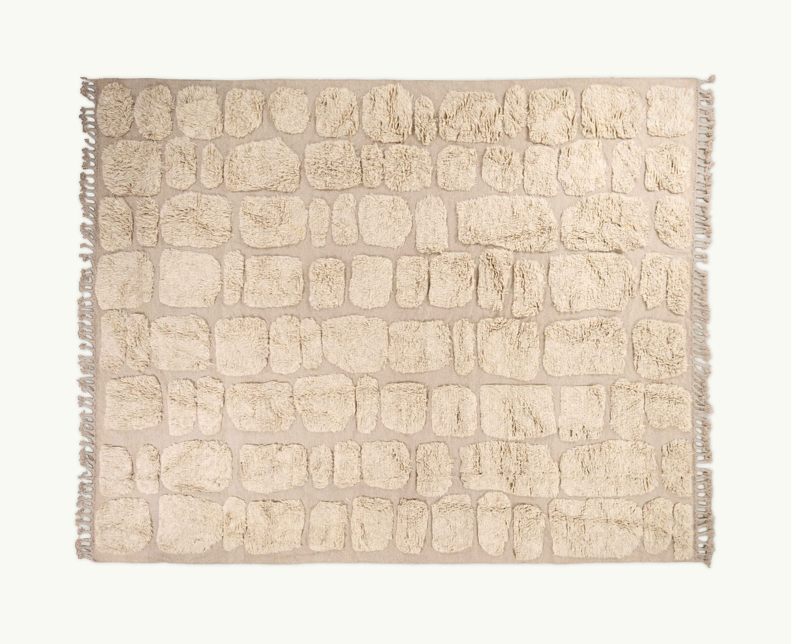 Gwyneth Paltrow | Cappelen Dimyr Textured Wool Carpet No. 3: A natural wool mixed-format high-low carpet with assorted elements in pile format overall on a buff field in kilim format and a braided chunky fringe edge.This item comes from Gwyneth Paltrow’s