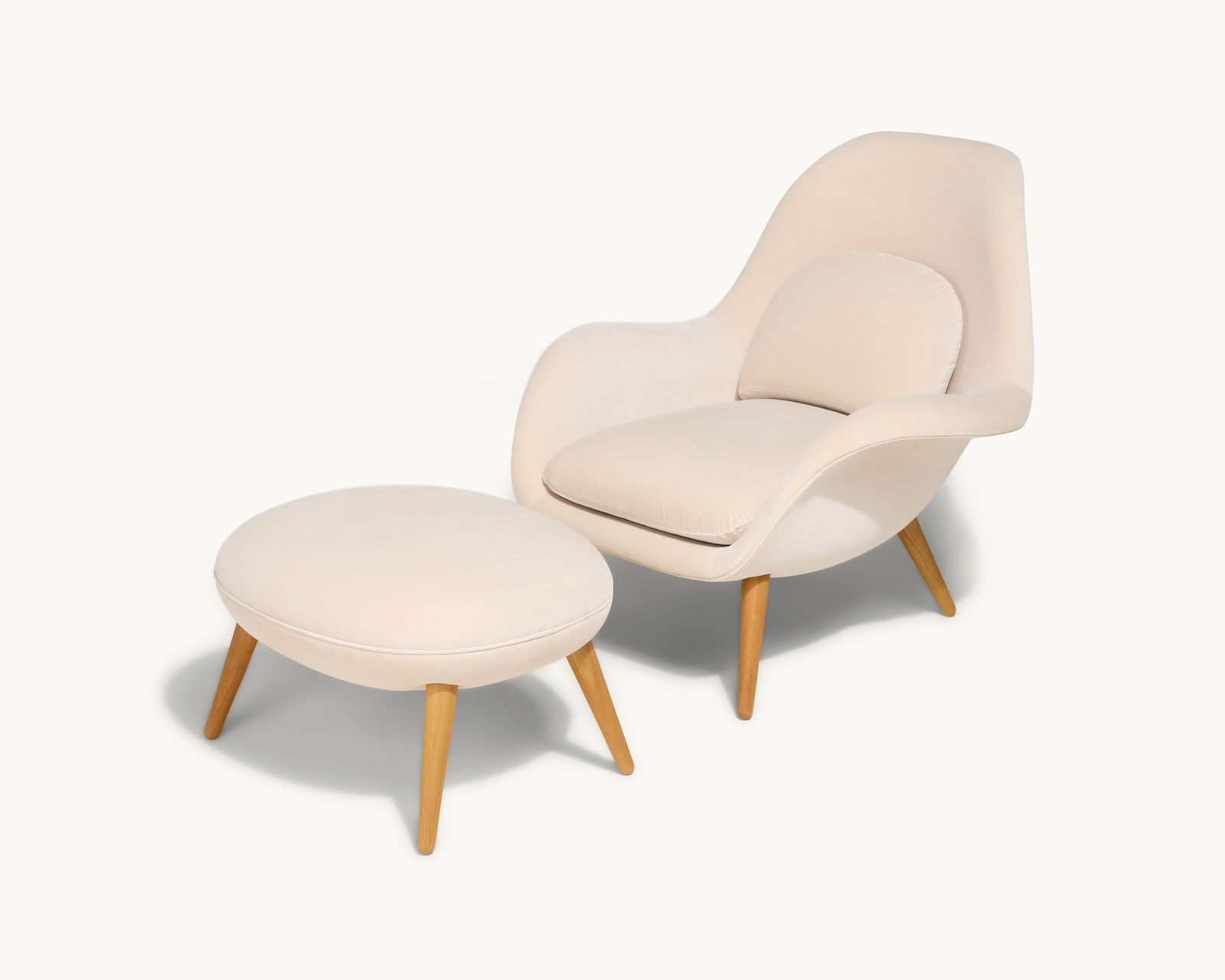 Gwyneth Paltrow | Fredericia Swoon Lounge Chair with Ottoman: An ivory velvet mohair Mid-century Modern style armchair with tapering wood legs and matching ottoman.This item comes from Gwyneth Paltrow’s Hamptons home, a peaceful retreat designed for comfor
