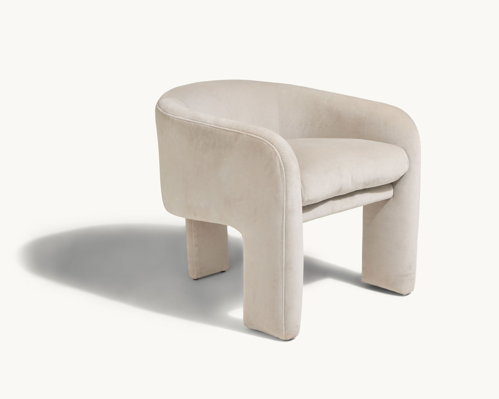 Gwyneth Paltrow | Milo Baughman Style Velvet Armchair: A horseshoe form grey velvet armchair in the manner of Milo Baughman, with three feet and a loose seat cushion.Milo Baughman (1923-2003) was a pioneering American designer whose modern, time
