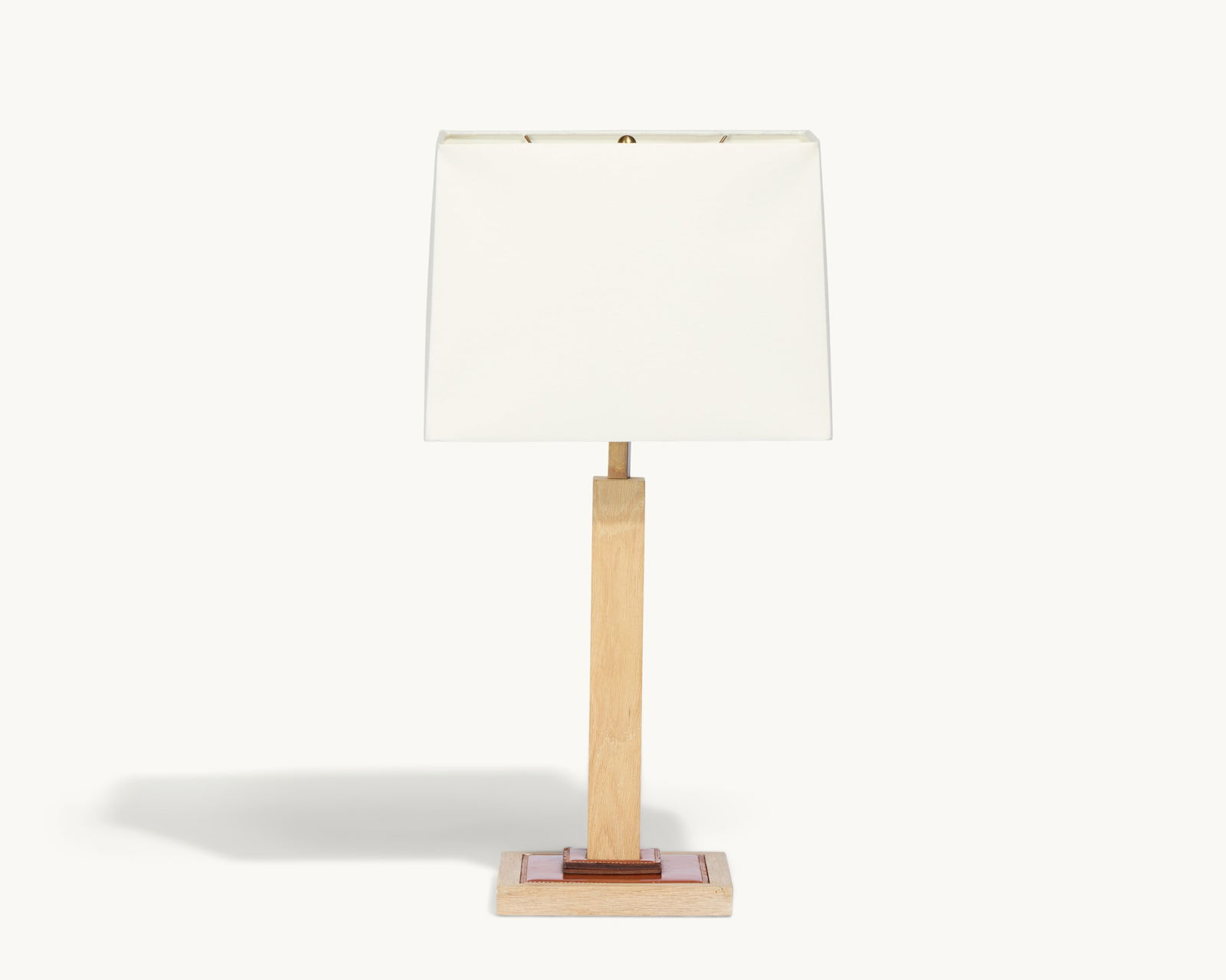 Gwyneth Paltrow | Wood and Leather Table Lamp: A table lamp with a square wood and stitched leather base and rectangular linen shade.This article is from Gwyneth Paltrow’s former Brentwood home in Los Angeles, where she collaborated with int