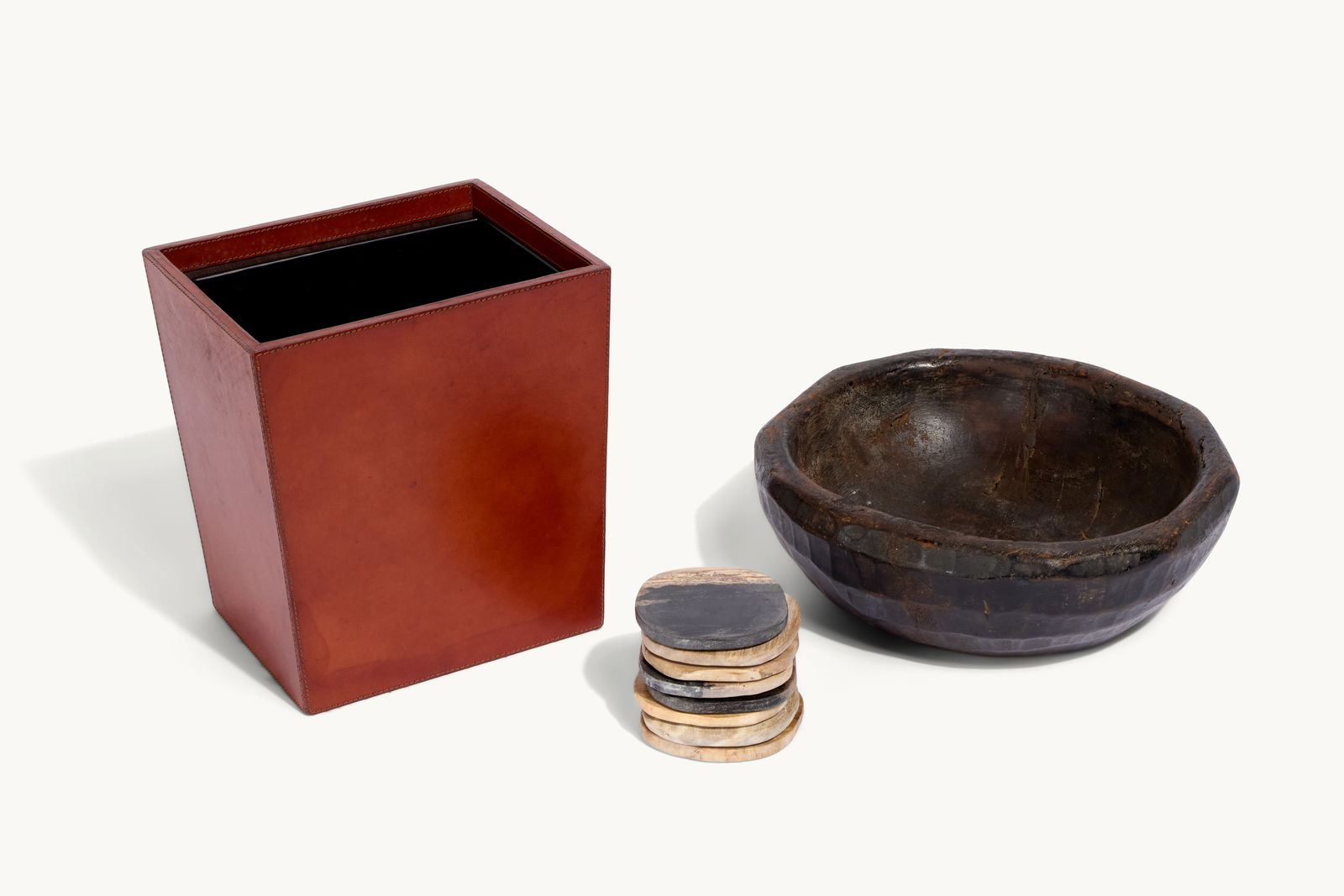 Gwyneth Paltrow | Group of Wood Stone and Leather Decorative Items: Including a wood pedestal bowl marked LF; a rectangular ash wood tray with brass hardware and wrapped handles; a woven tray with a teak frame, two Pigeon & Poodle woven wastebaskets with metal liners,