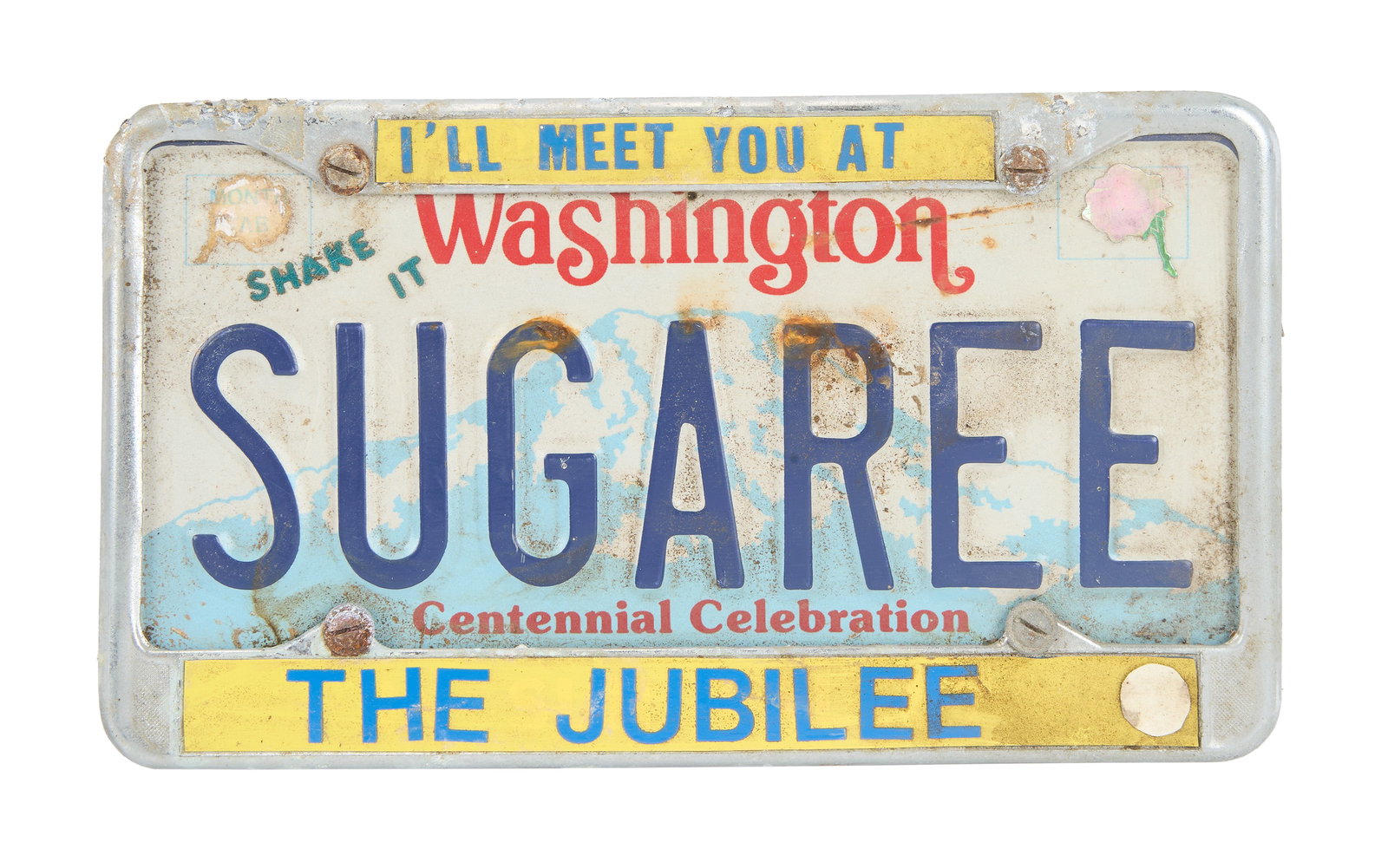"Big Steve" Parish | SUGAREE License Plate Thrown On Stage By Fan: A vintage Washington license plate in a "I'll Meet You At The Jubilee" metal frame that reads "SUGAREE " thrown by a fan on stage at a Grateful Dead concert c. late 1970s-early 1980s. The back is deco
