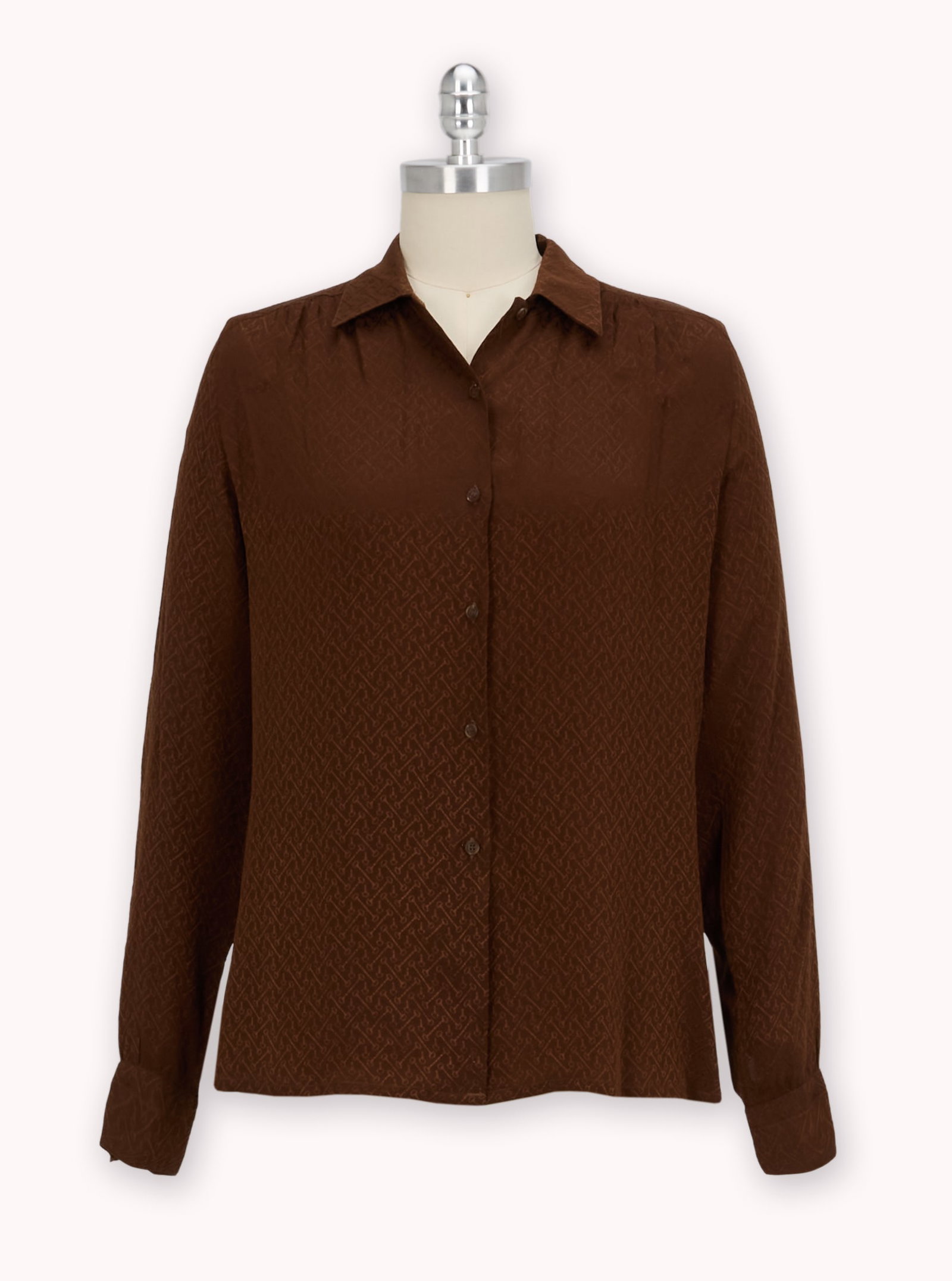 And Just Like That... | Miranda Hobbes Season 2 Episode 8, Gucci Silk Blouse: A Gucci brown silk blouse with all over horse bit pattern worn by the character Miranda Hobbs in the Max Original series And Just Like? The blouse was worn in season two, episode eight of the series.