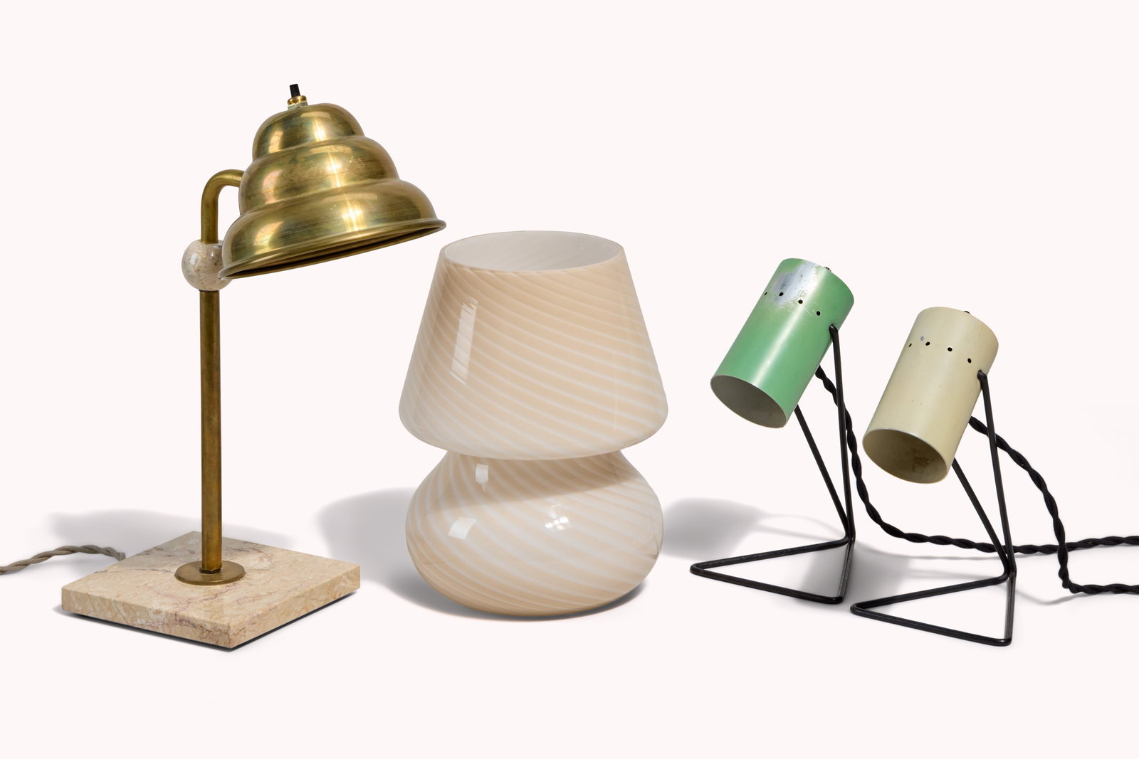 And Just Like That... | Carrie Bradshaw's Group of Four Table Lamps: A group of four assorted table lamps, including a brass lamp with a marble base, a blush and white spiraled glass lamp, and a green and an ivory can lamp with black metal bases. These items were locat