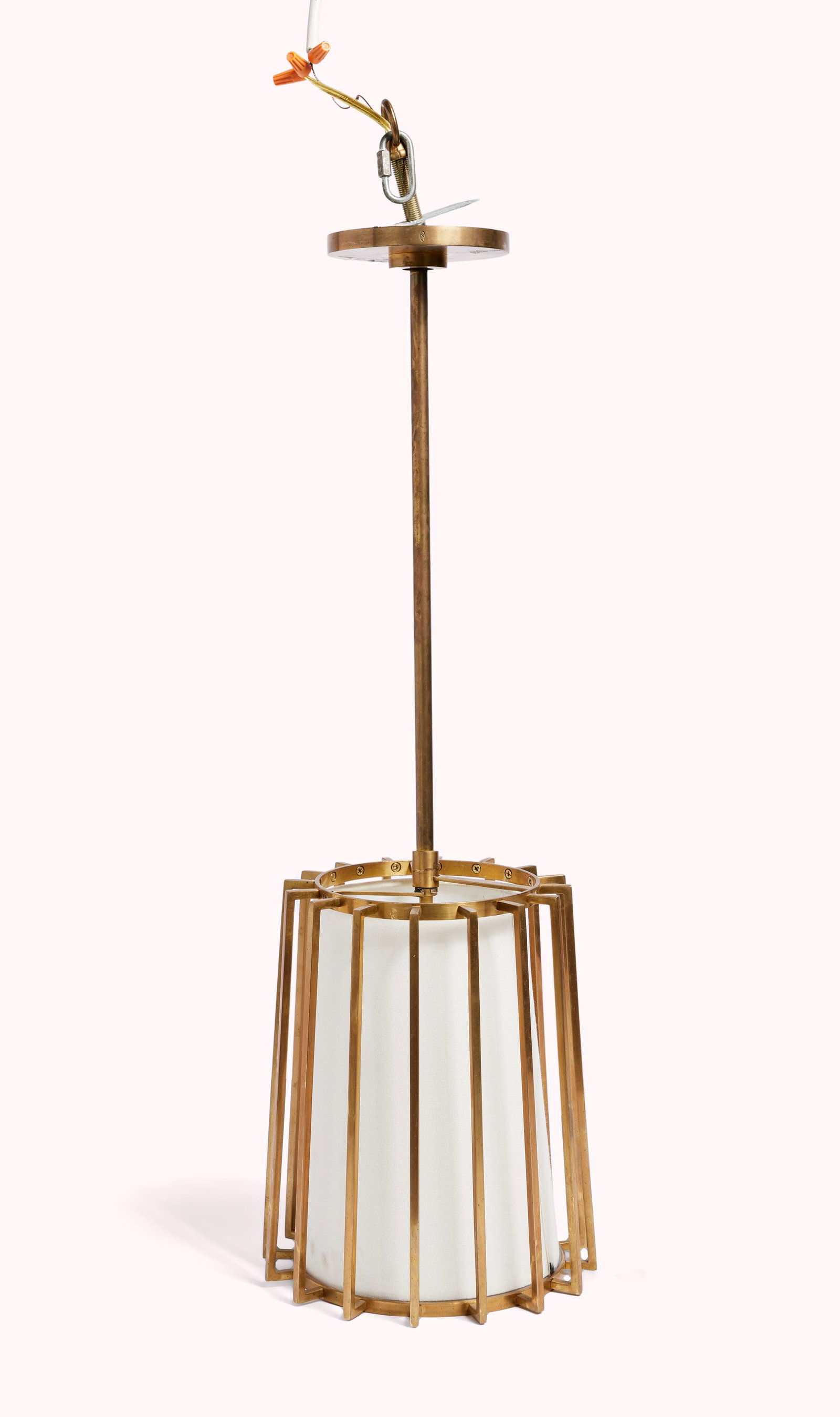 And Just Like That... | Pendant Brass Cage Lamp: A Mid-century Modern style brass cage-form chandelier with an interior linen shade. A one-time donation will be made by Warner Bros. Discovery to You Gotta Believe (YGB) at the conclusion of the aucti