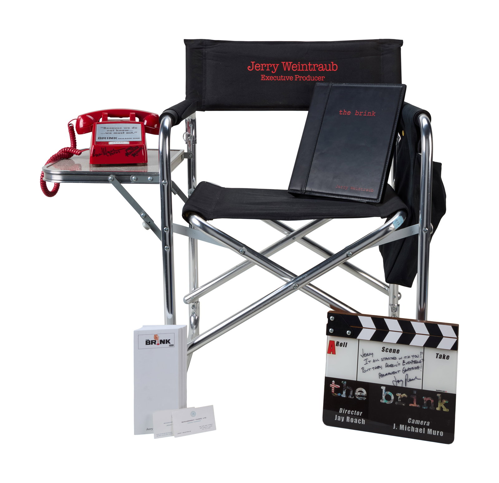 Jerry Weintraub | "The Brink" Production Memorabilia: A group of items from the production and promotion of the television series, The Brink (HBO, 2015). Items include: A presentation clapperboard signed and inscribed by pilot episode director Jay Roach