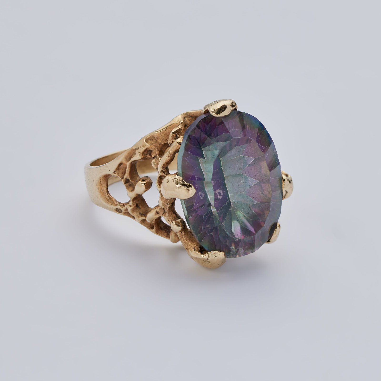 Jerry Weintraub | 14K Yellow Gold and Synthetic Color Change Sapphire Ring: An original 14k yellow gold and synthetic color change sapphire ring owned and worn by Jane Morgan.The ring centers upon an oval-cut synthetic color change sapphire, within a textured and openwork
