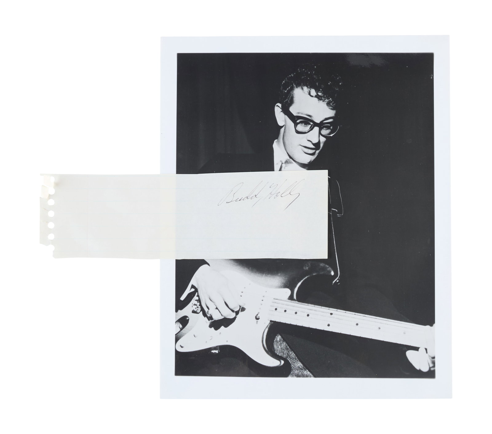 Buddy Holly | Signed Cut Sheet with Black and White Photo: A cut sheet of lined note paper signed in black ink by Buddy Holly. Accompanied by a black and white image of Holly.