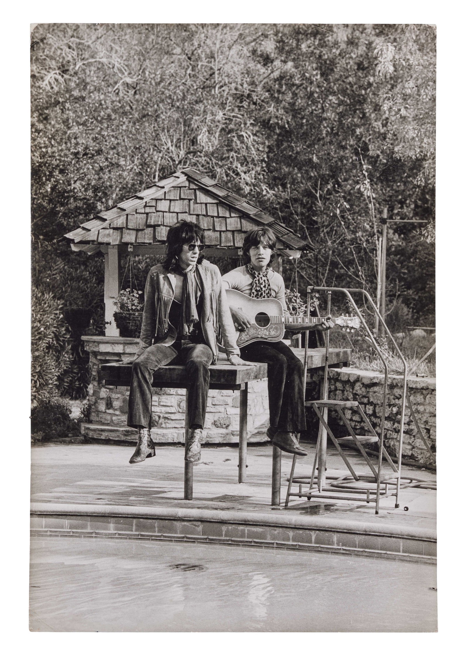The Rolling Stones | 1969 Terry O'Neill Photo of Mick Jagger And Keith Richards: A vintage black-and-white photograph of Mick Jagger and Keith Richards, taken by Terry O'Neill in October of 1969 at the home of Stephen Stills in Laurel Canyon California. Stamped "Photograph by Terr