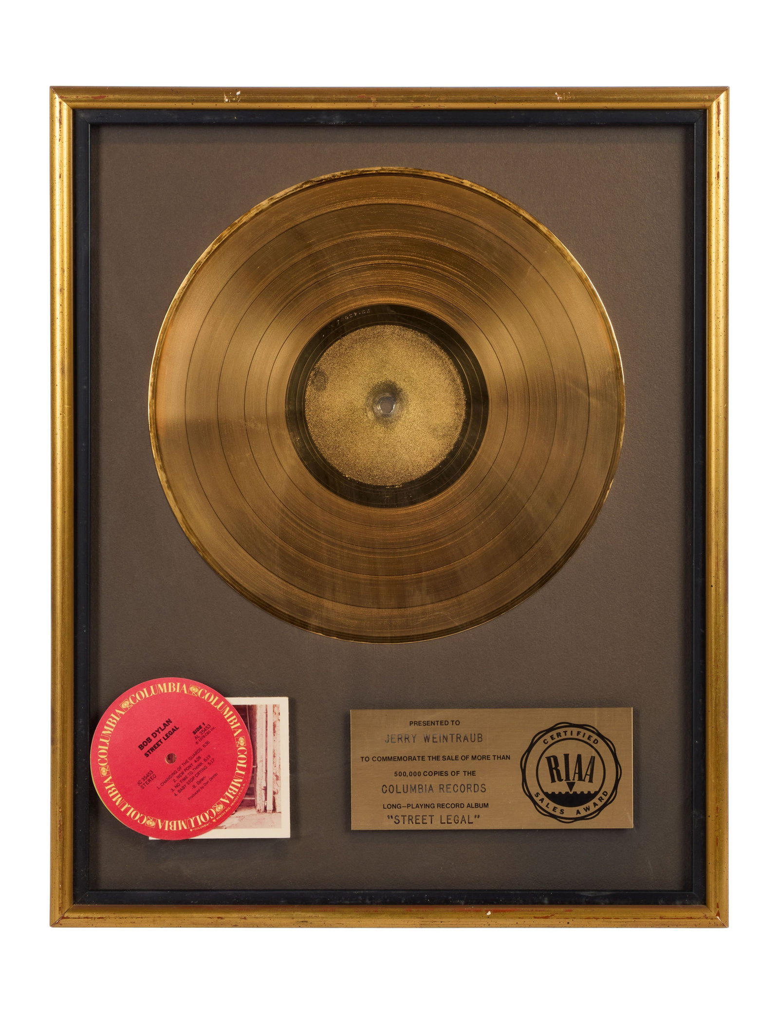 Bob Dylan | RIAA-Certified "Gold" Sales Award for "Street Legal" Presented to Jerry Weintraub: An RIAA-Certified "Gold" Sales Award presented to concert promoter and producer Jerry Weintraub to commemorate the sale of more than 500,000 copies of Bob Dylan's long-playing record album Street