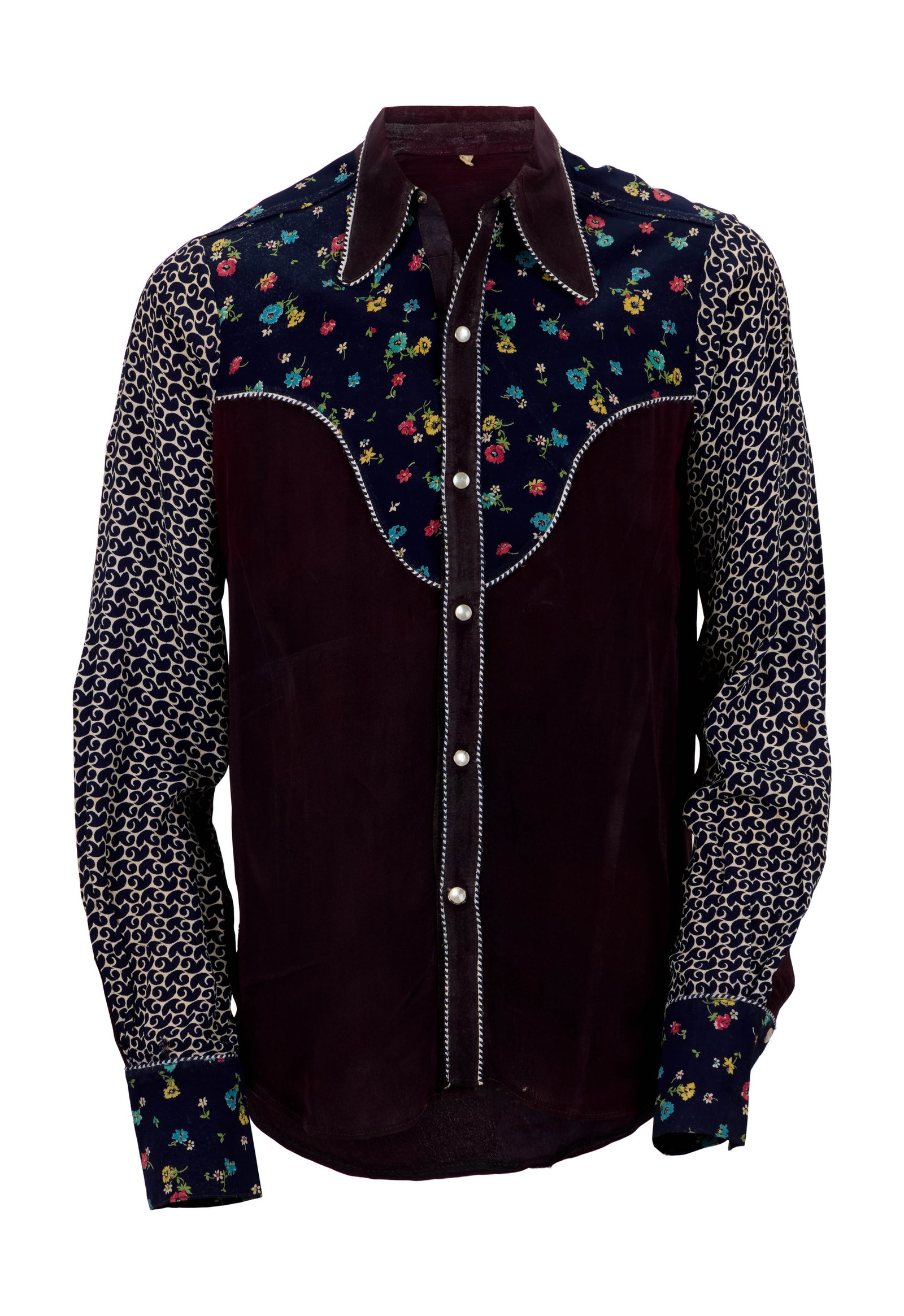 Eric Clapton | Vintage Western Shirt: A patchwork western-style shirt, previously owned by Eric Clapton and gifted to David English. The shirt features a floral-patterned yoke and sleeve cuffs, navy blue and cream patterned sleeves, strip