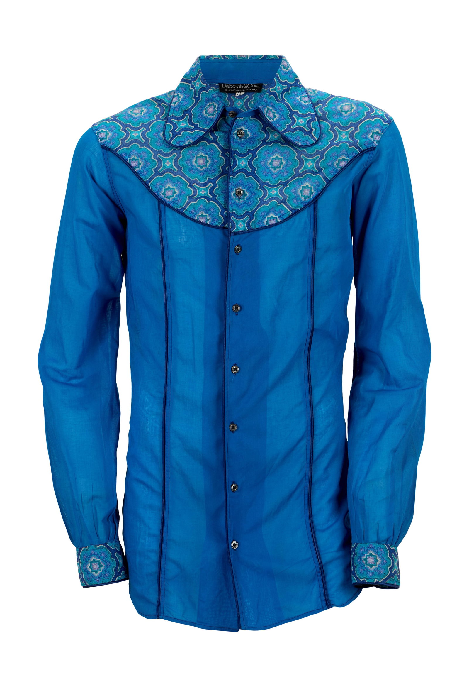 Eric Clapton | Vintage Western Shirt: A blue western-style shirt, previously owned by Eric Clapton and gifted to David English. The shirt features a patterned yoke and sleeve cuffs, a Peter Pan collar, and navy blue piping. Labeled "Debor