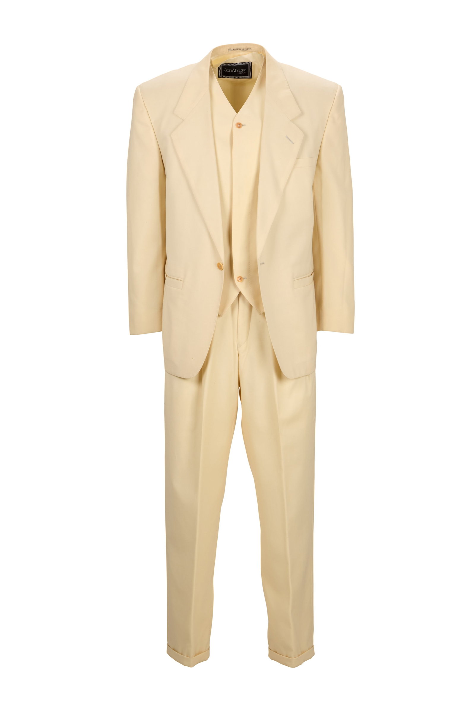 Eric Clapton | 1983 Custom-Made Cream Gianni Versace Suit: A three-piece cream Gianna Versace Couture suit, custom-made for Eric Clapton by Versace, c. 1983. The 100% wool suit comprises a single-button-front jacket, a matching button-down vest, and a p