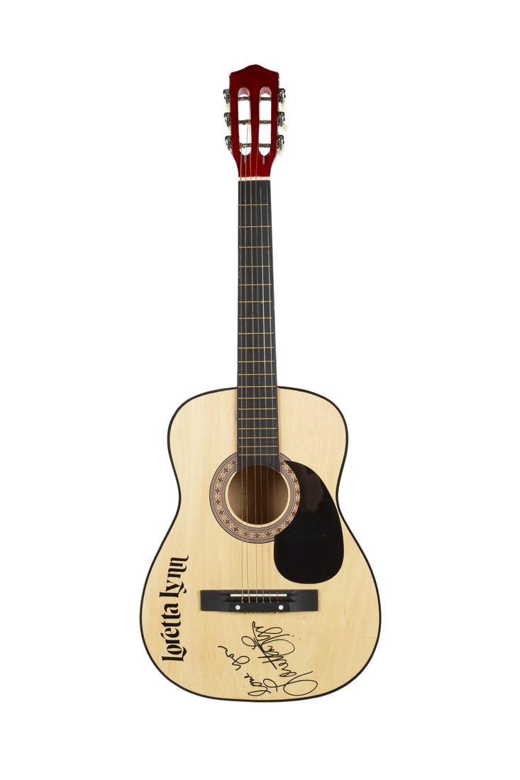 Loretta Lynn | Signed and Inscribed Acoustic Guitar: An unbranded child's acoustic guitar with black letter stickers which spell out Loretta Lynn's name on the top. The guitar is signed in black felt tip pen by Loretta Lynn herself along with the inscri