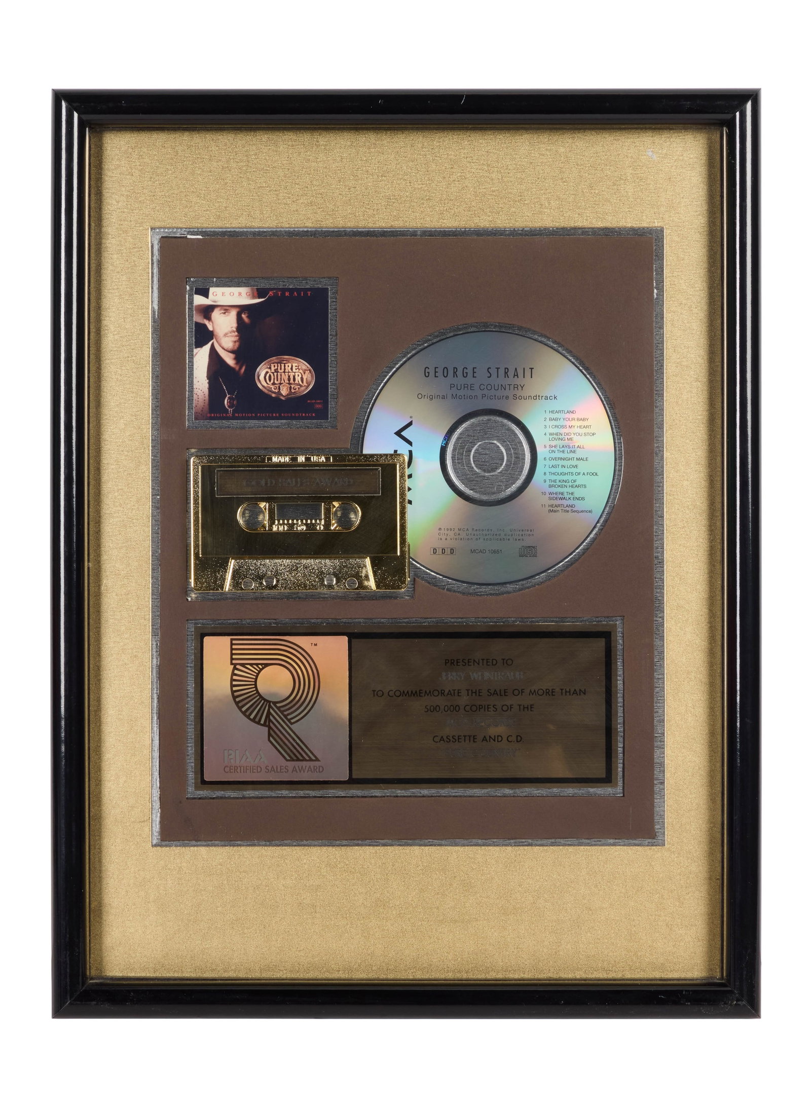 George Strait | RIAA-Certified "Gold" Sales Award for "Pure Country" Soundtrack Presented to Jerry: An RIAA-Certified "Gold" Sales Award presented to concert promoter and producer Jerry Weintraub to commemorate the sale of more than 500,000 cassette and C.D. copies of George Strait's